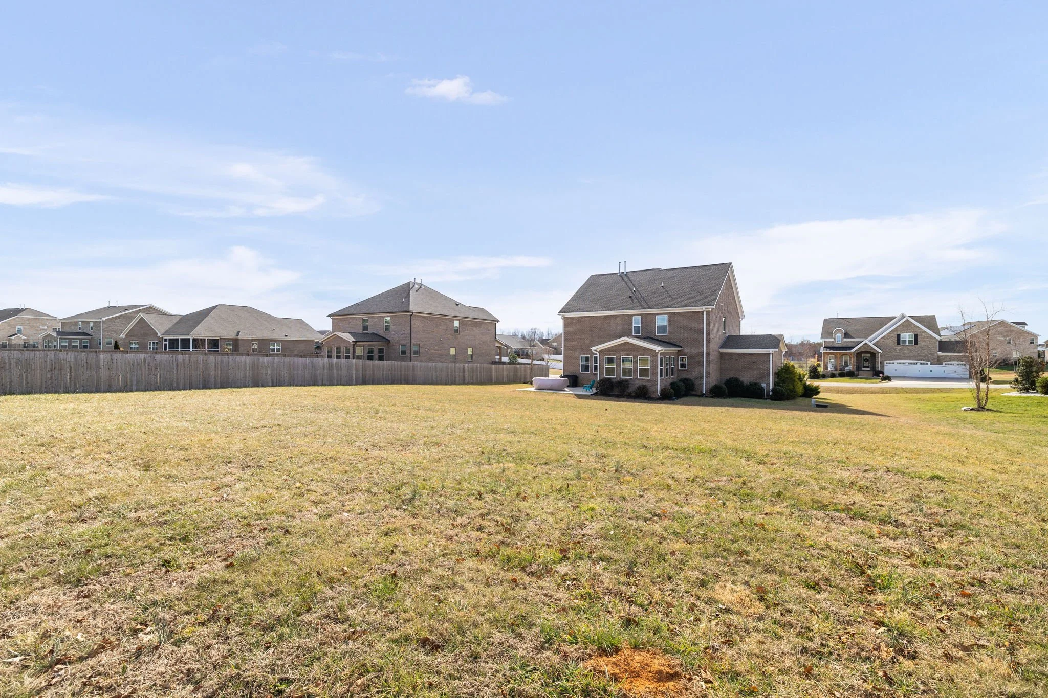 Wide-angle backyard view with privacy fencing at 8012 NW Meadows Drive, Stokesdale, NC 27357. Listed by Delia Knight, REALTOR® with Howard Hanna Allen Tate Real Estate.