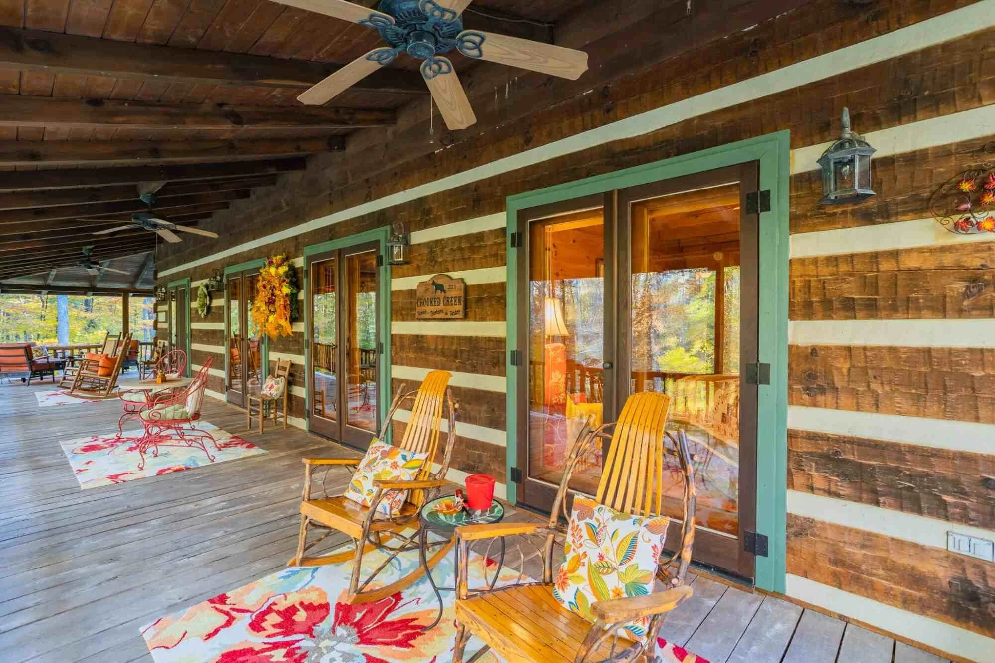 Covered porch with rocking chairs and open doors on rural Piedmont Triad home