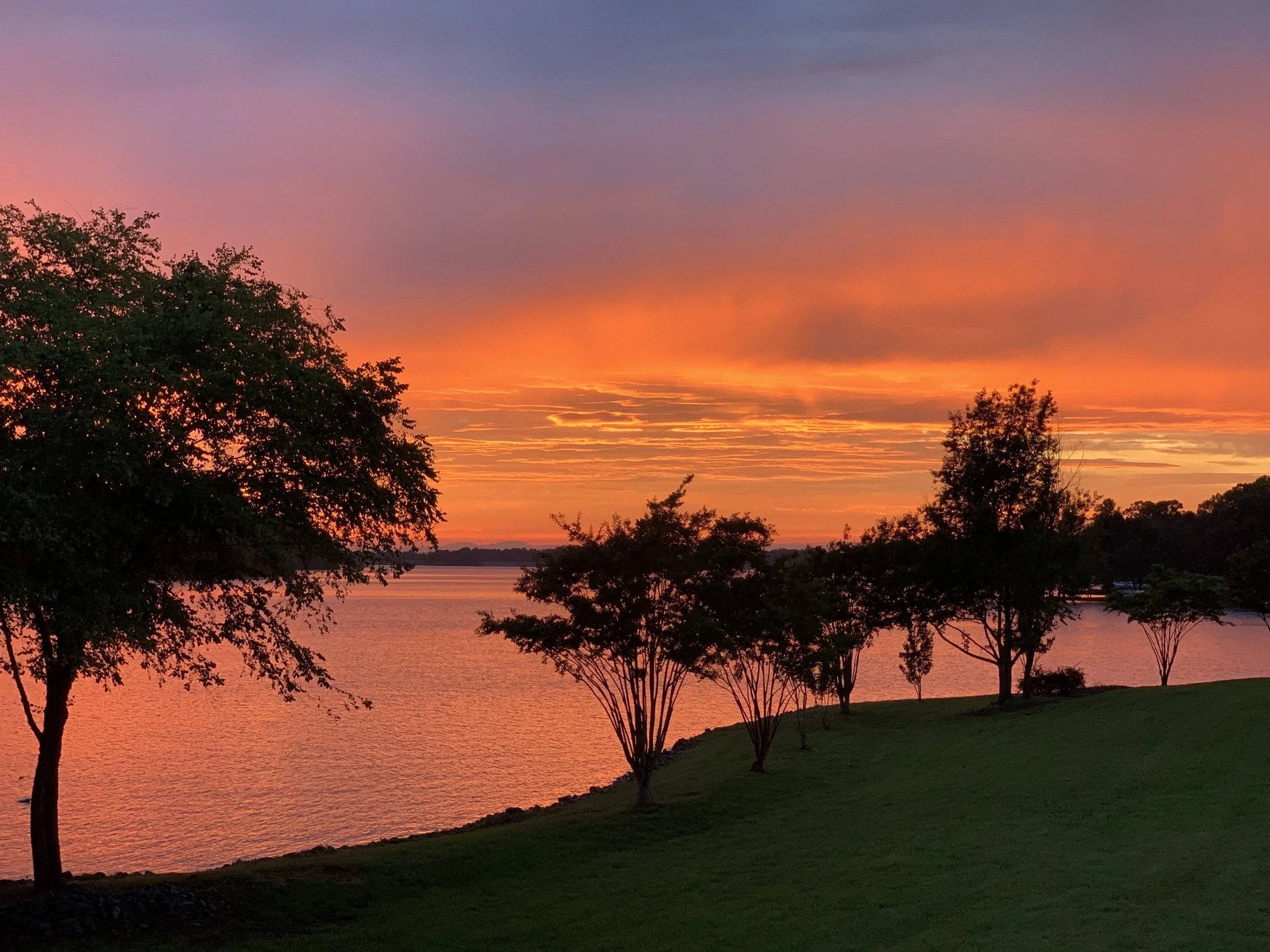 Belews Lake NC sunset view with trees and shoreline — Piedmont Triad NC