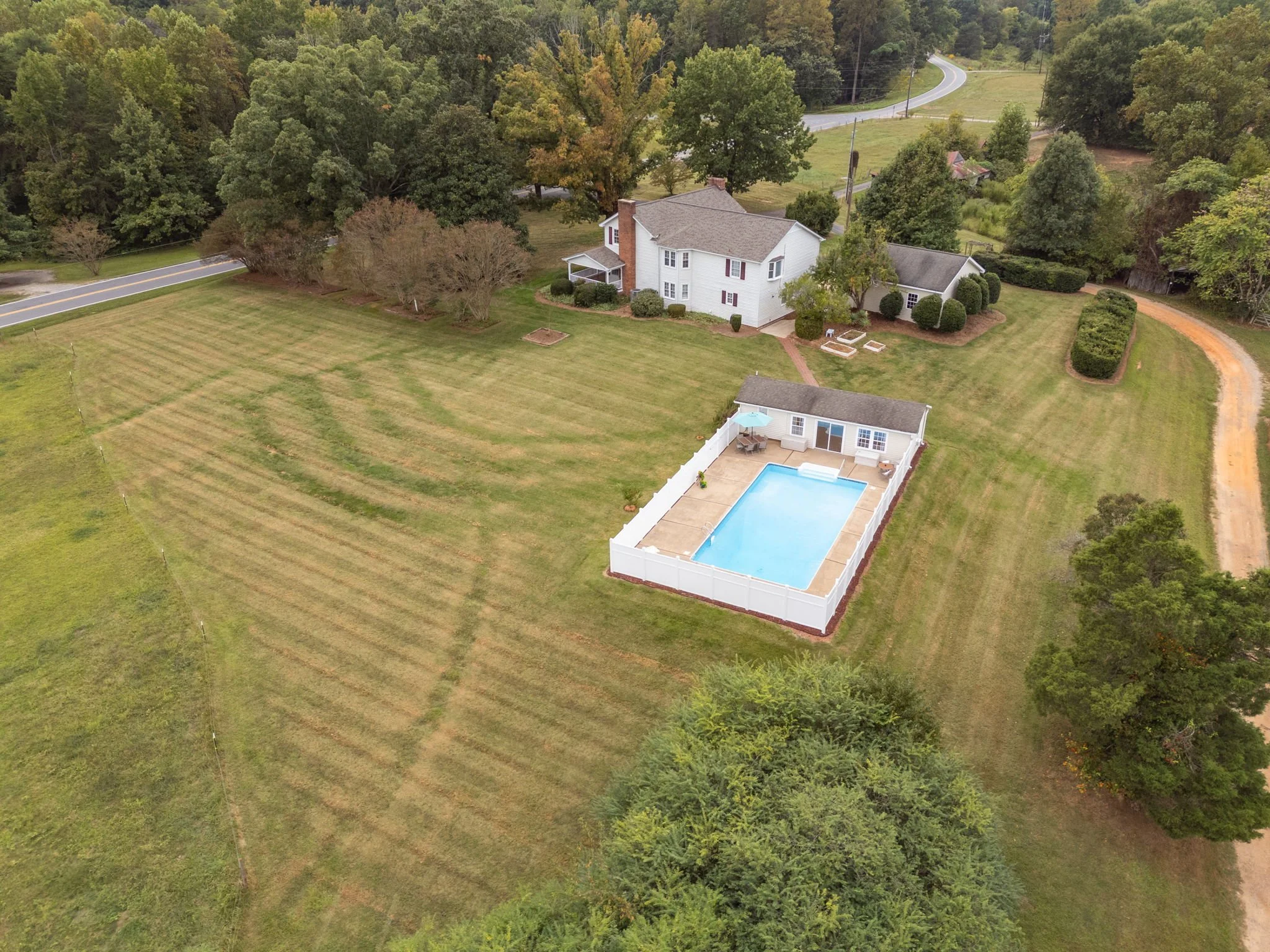 Aerial view of 2190 Lindsey Bridge Rd, Madison, NC – full property layout showing farmhouse, pool, detached garage, and 2.14-acre lot, listed by Delia Knight, REALTOR®