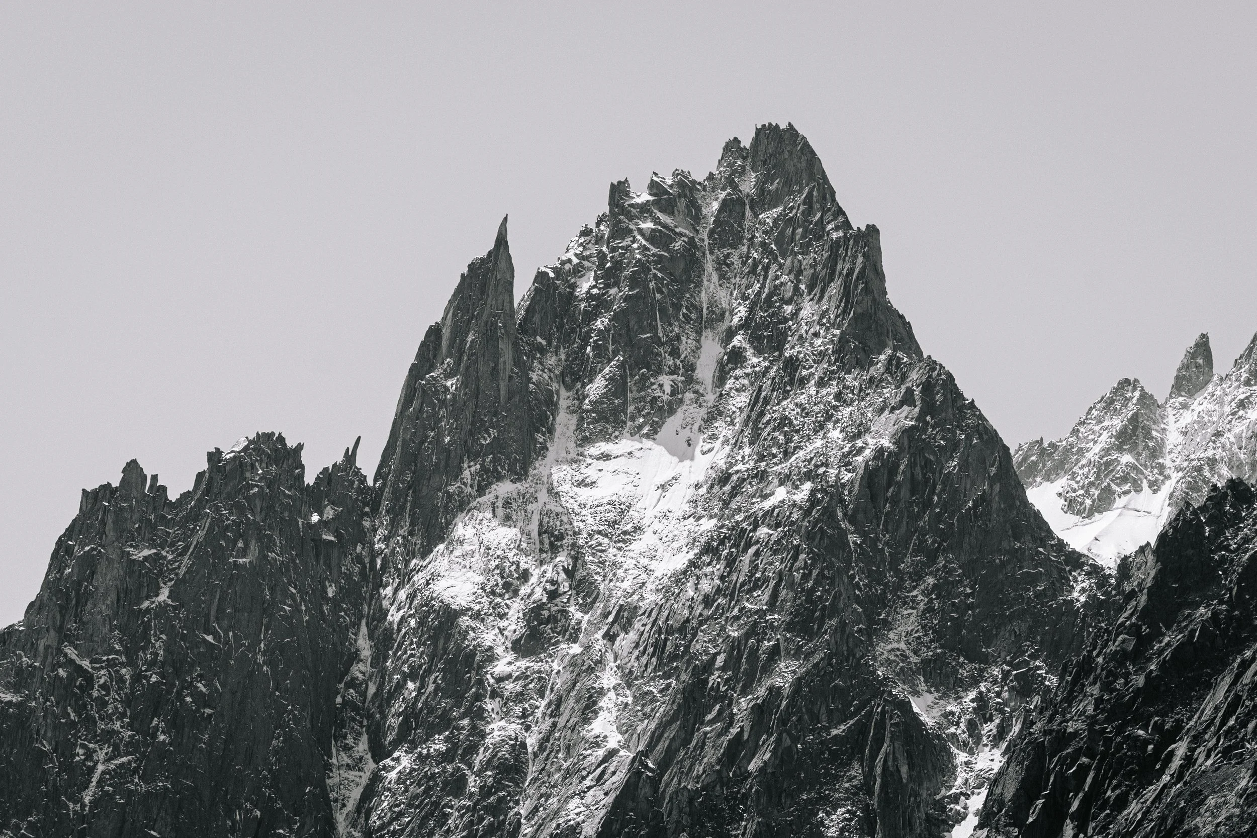 Aigulle des Grands Charmoz. A photograph taken in Chamonix with snow on mountain tops.