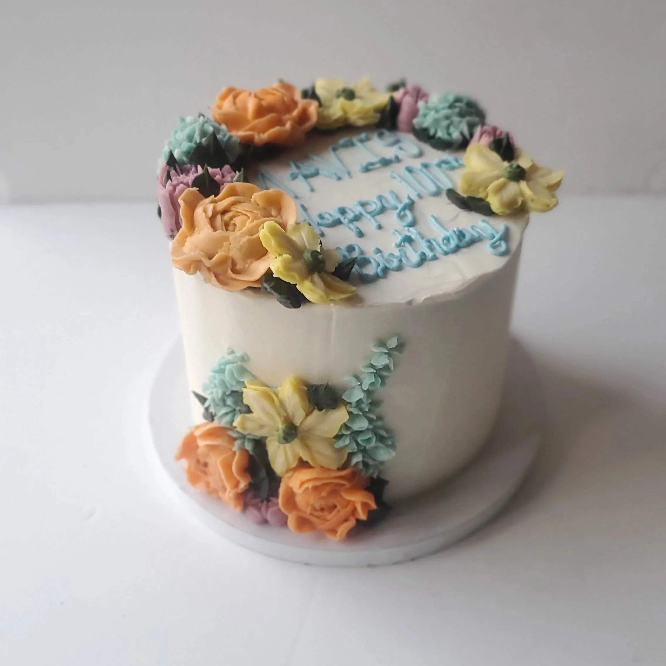 100th birthday cake with pastel buttercream flowers