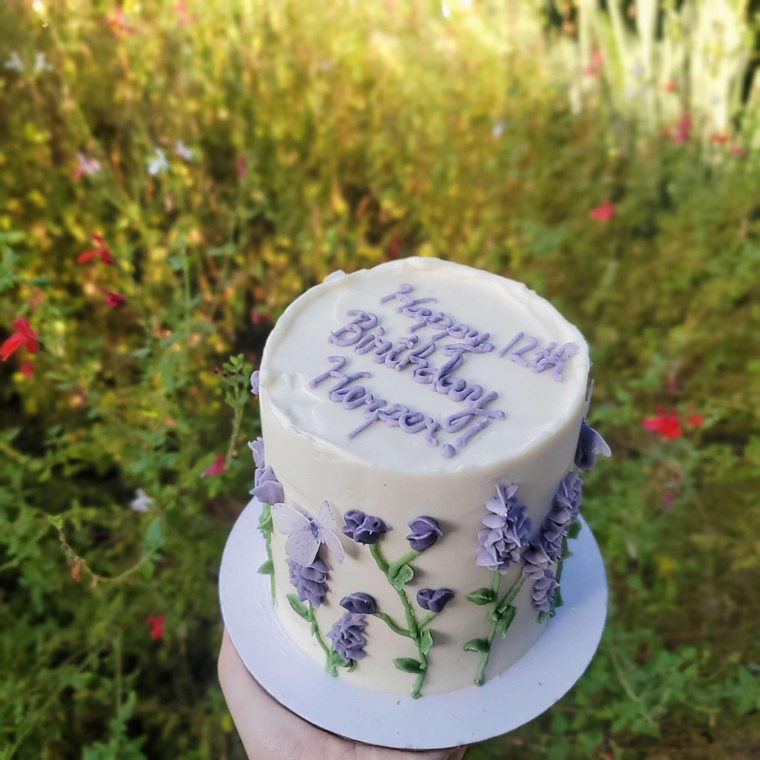 purple buttercream wildflower birthday cake