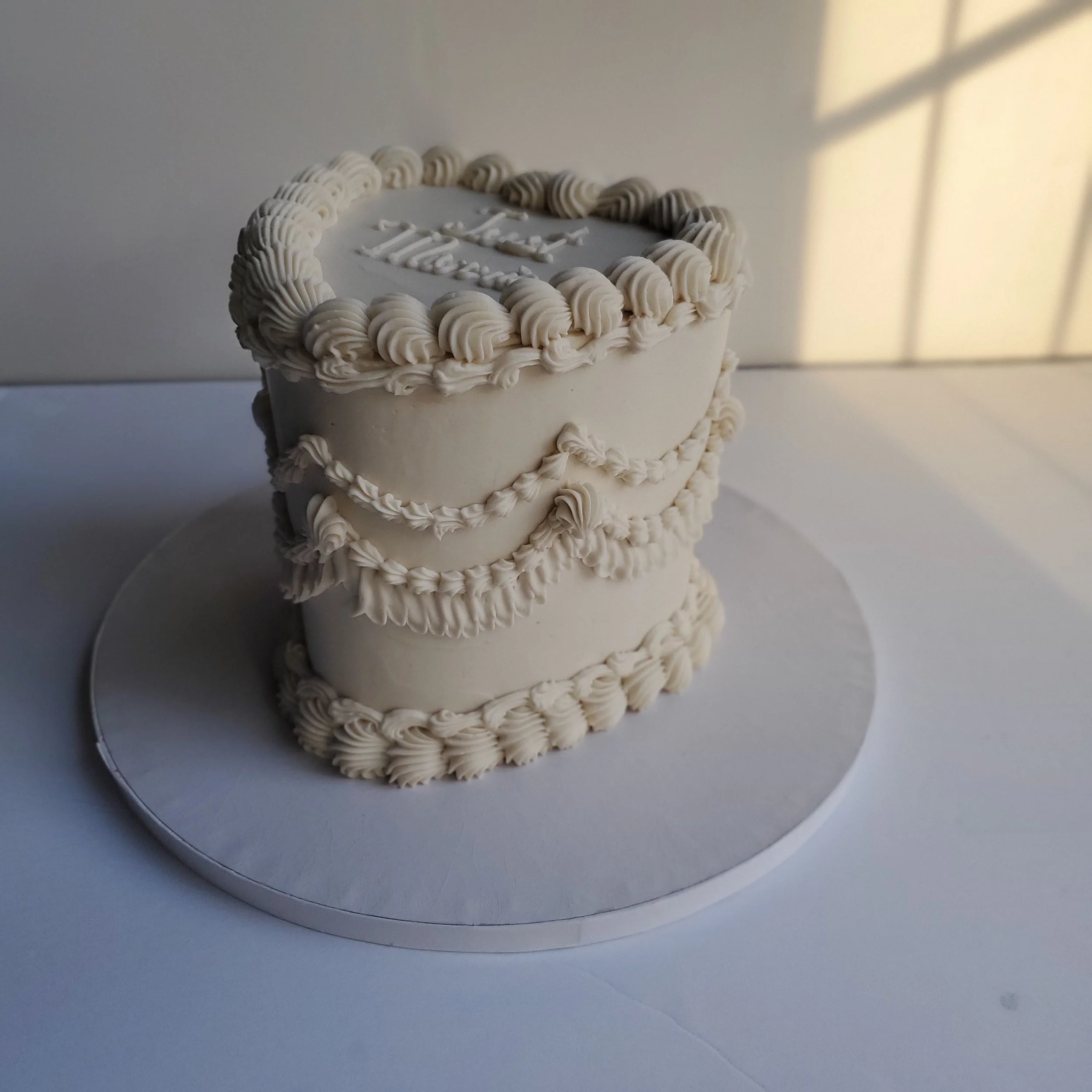 white vintage heart wedding cake