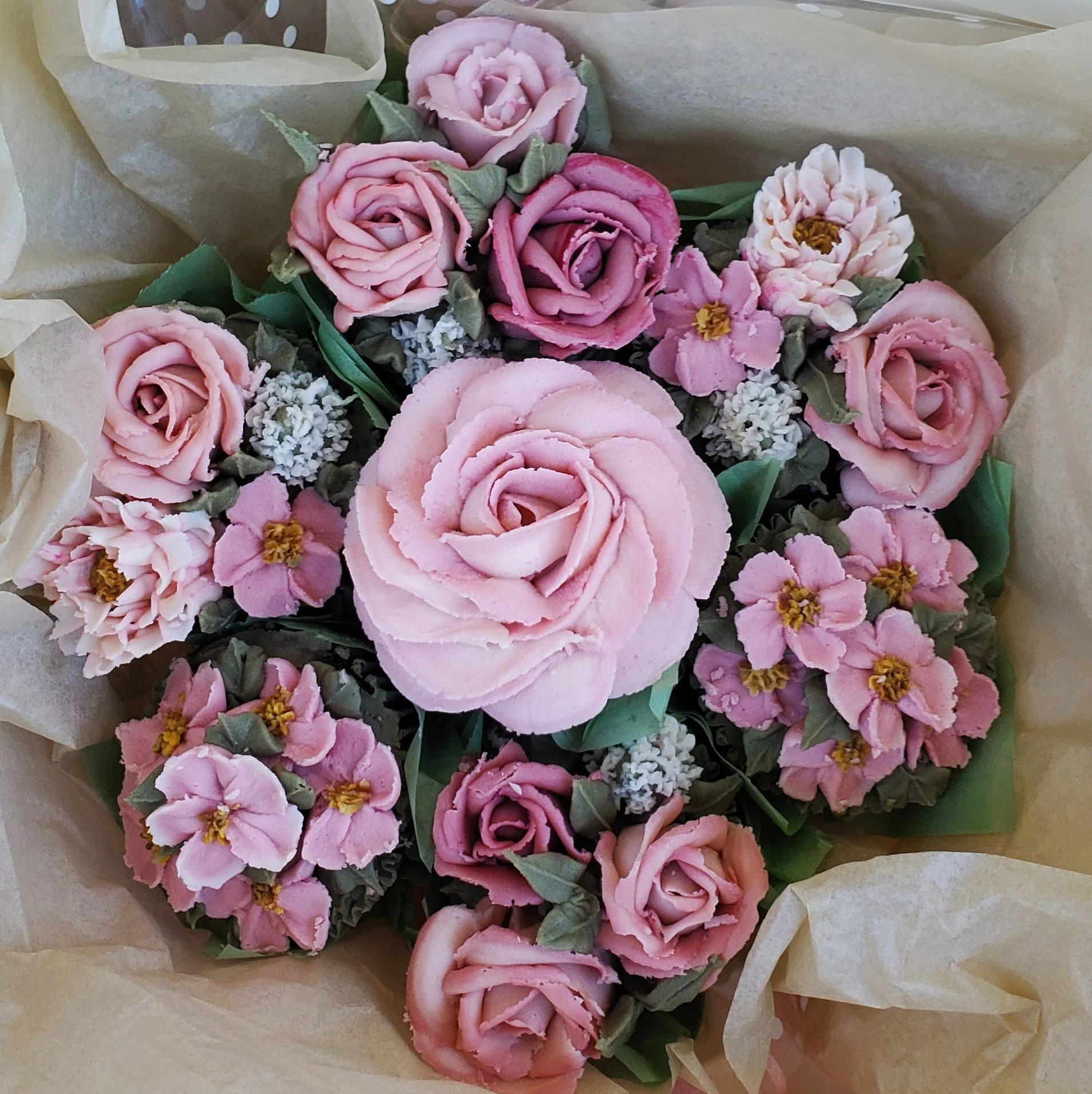 buttercream floral cupcake bouquet with roses in shades of pink