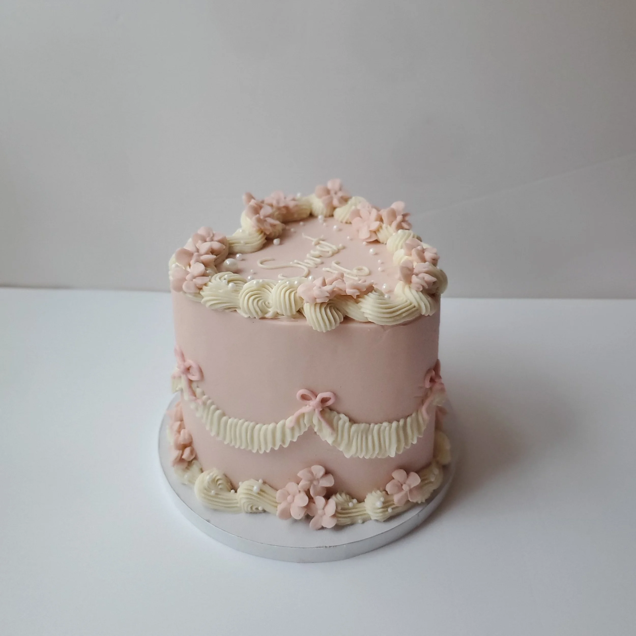 pink and white vintage sweet 16 cake with flowers
