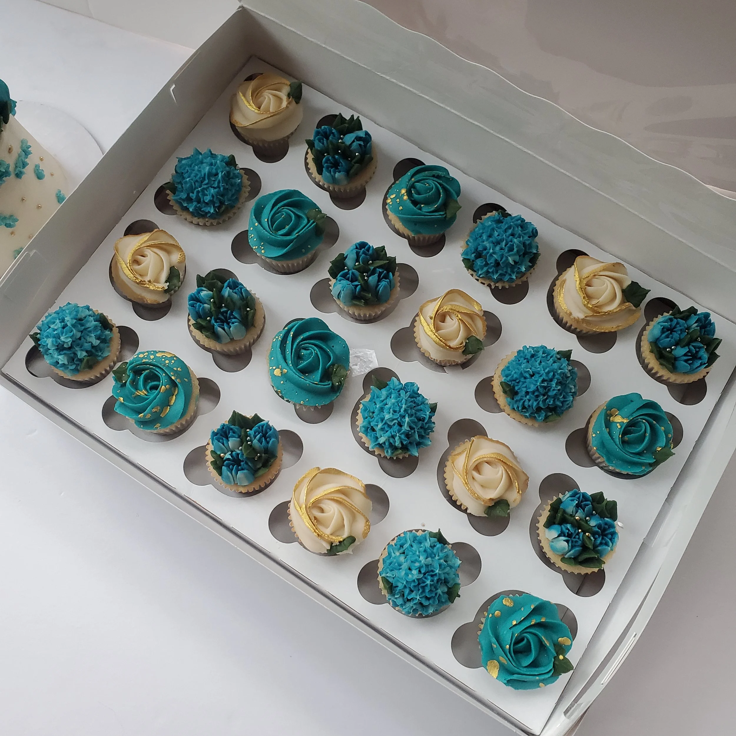 blue white, and gold mini flower cupcakes