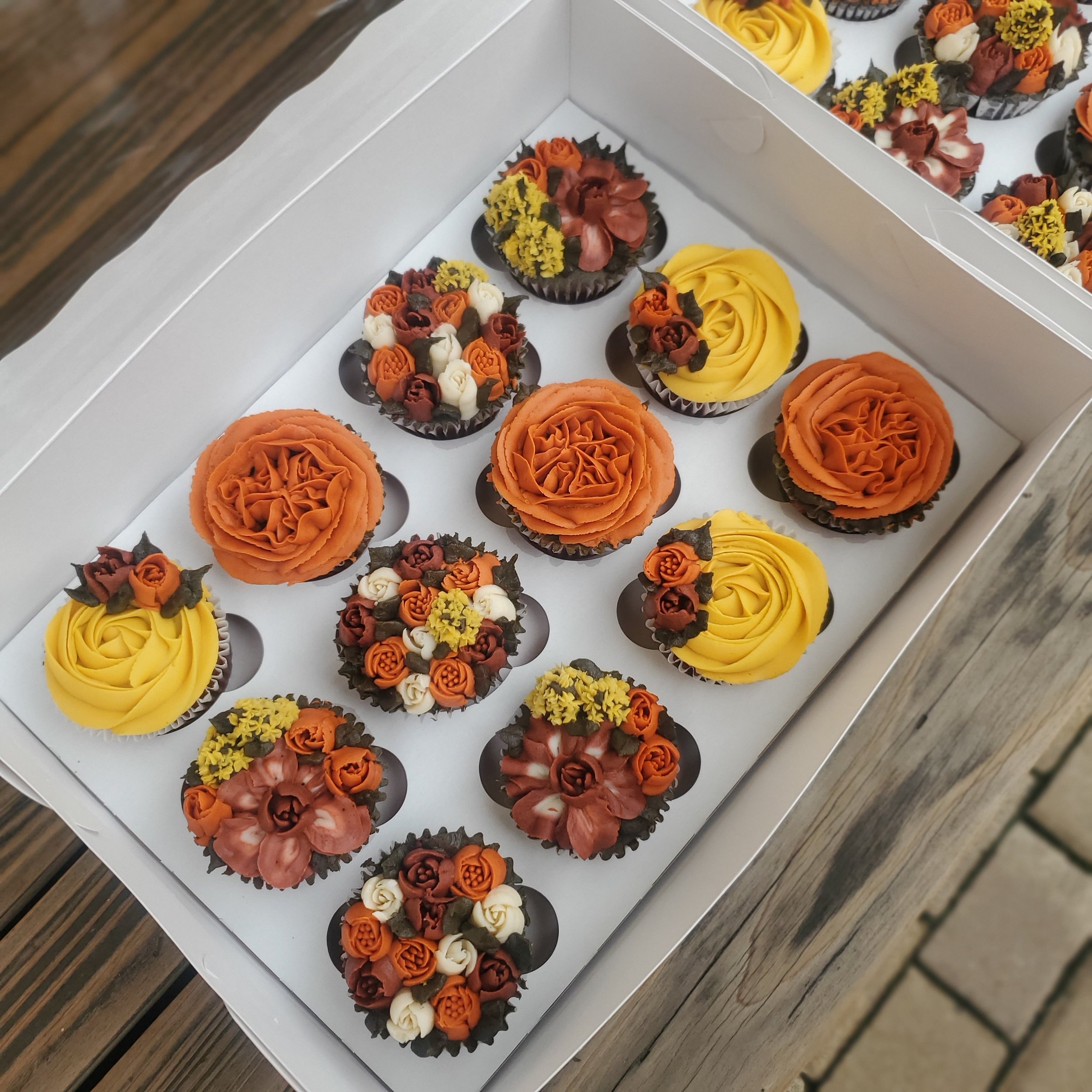orange, yellow, and burgundy buttercream floral cupcakes