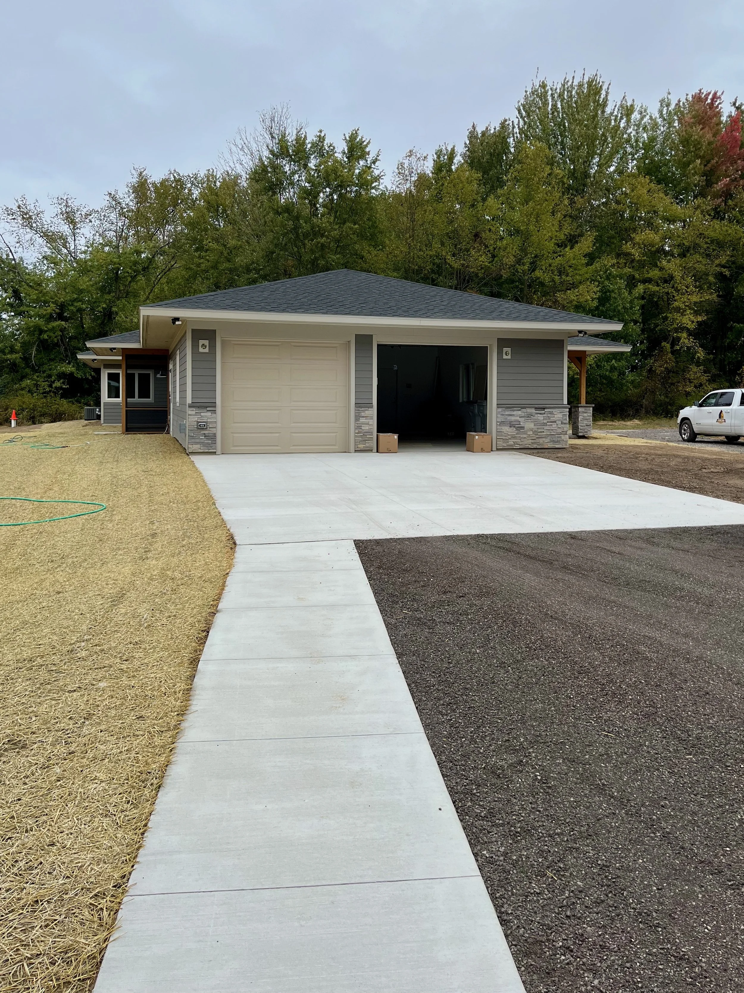 New sidewalk approach along driveway leading up to garage.