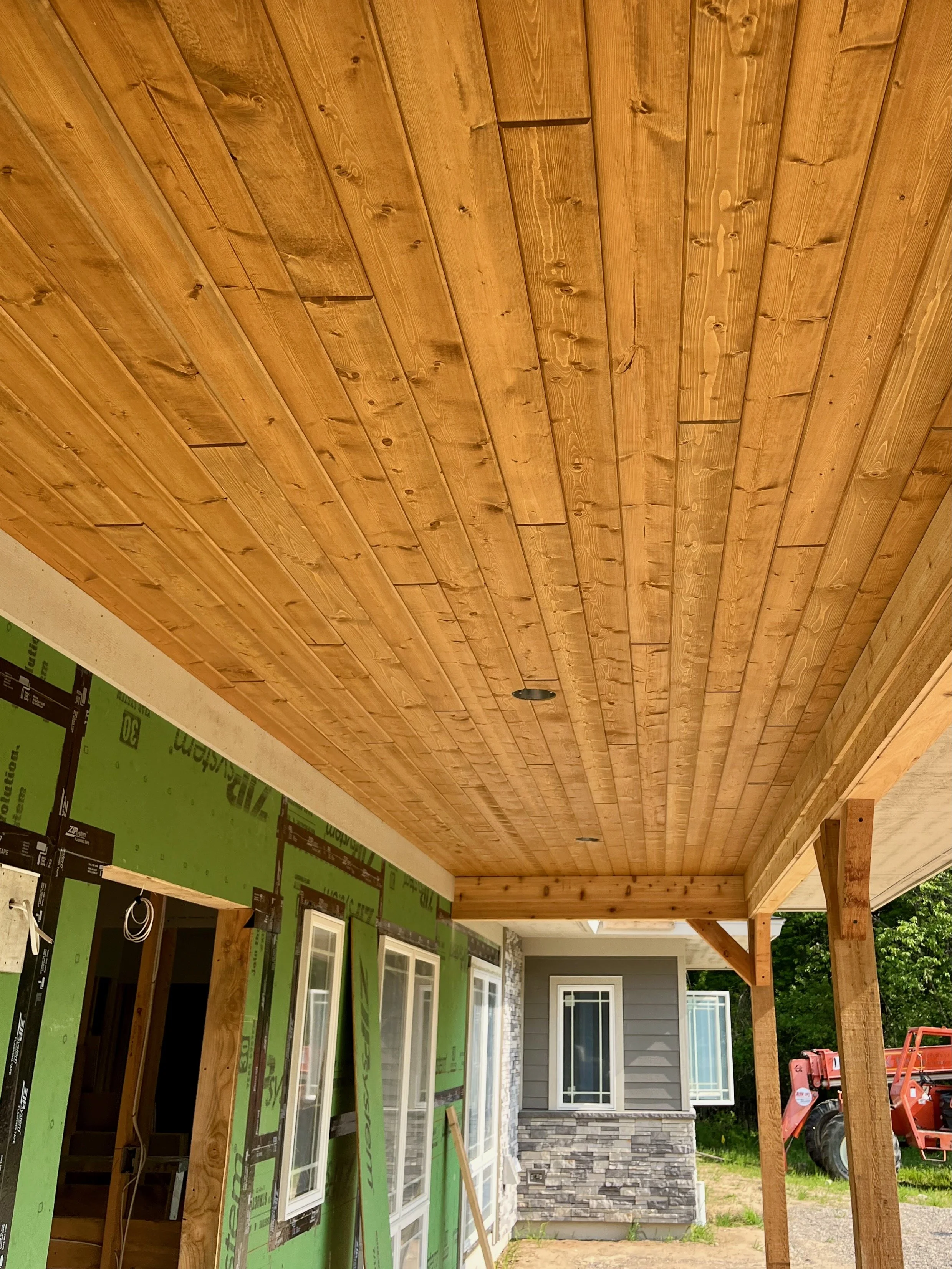 Wood plank ceiling of a porch.