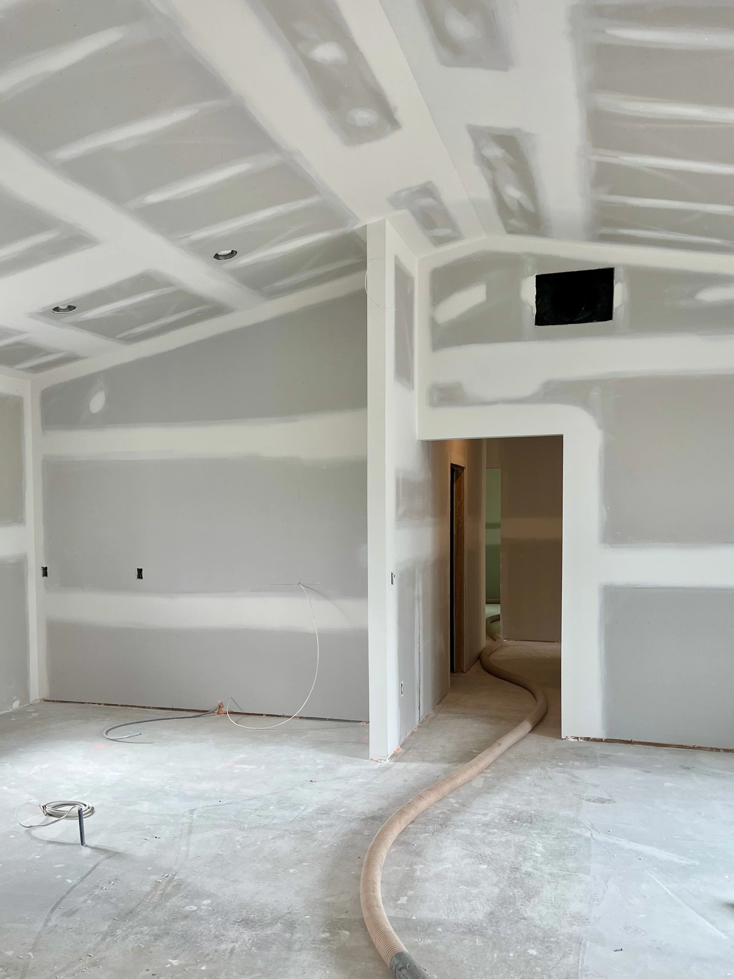 Interior of a room with drywall that has been mudded and taped.