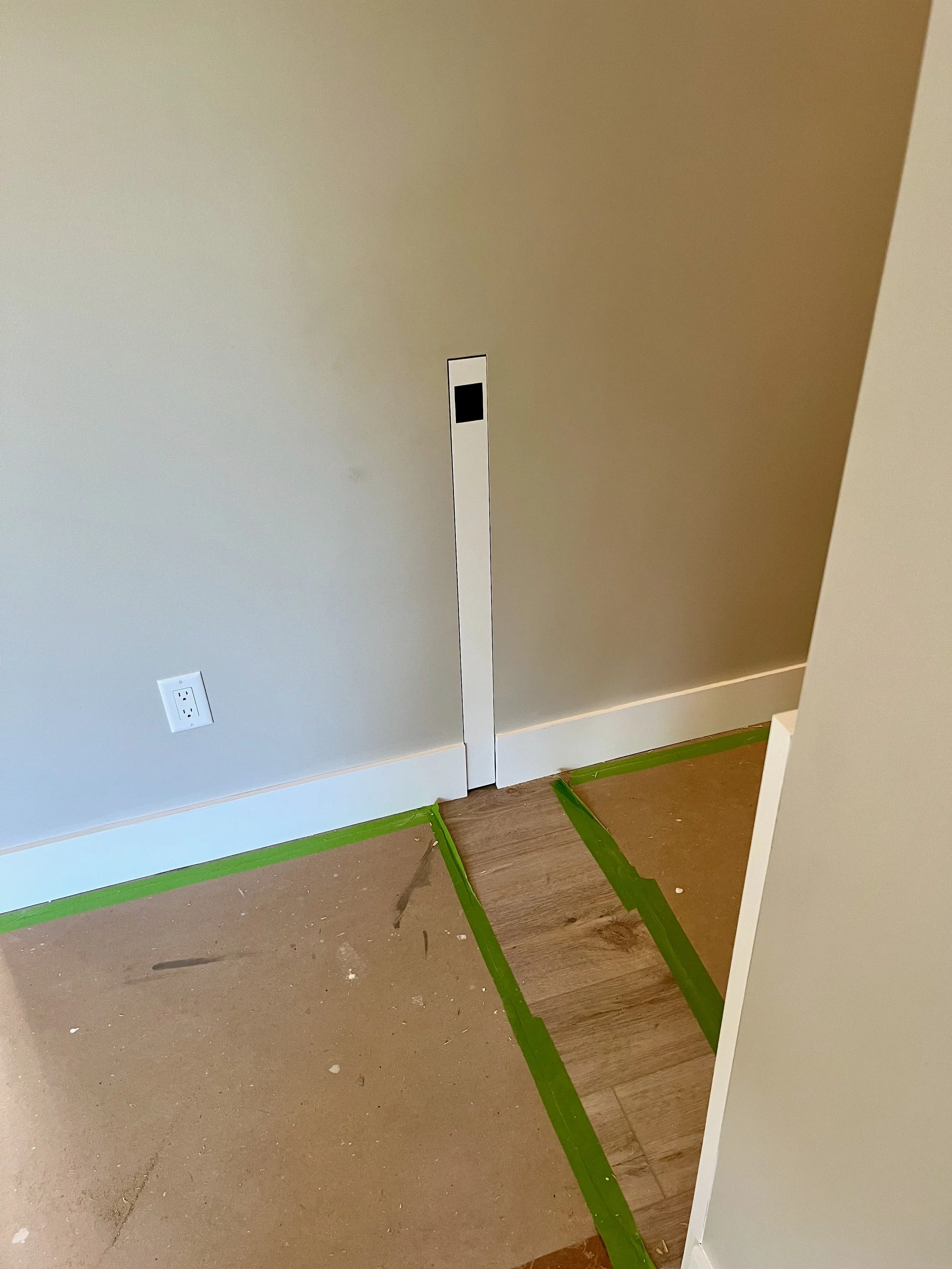 Sliding dog gate hidden inside a wall to allow for free movement through hallway.