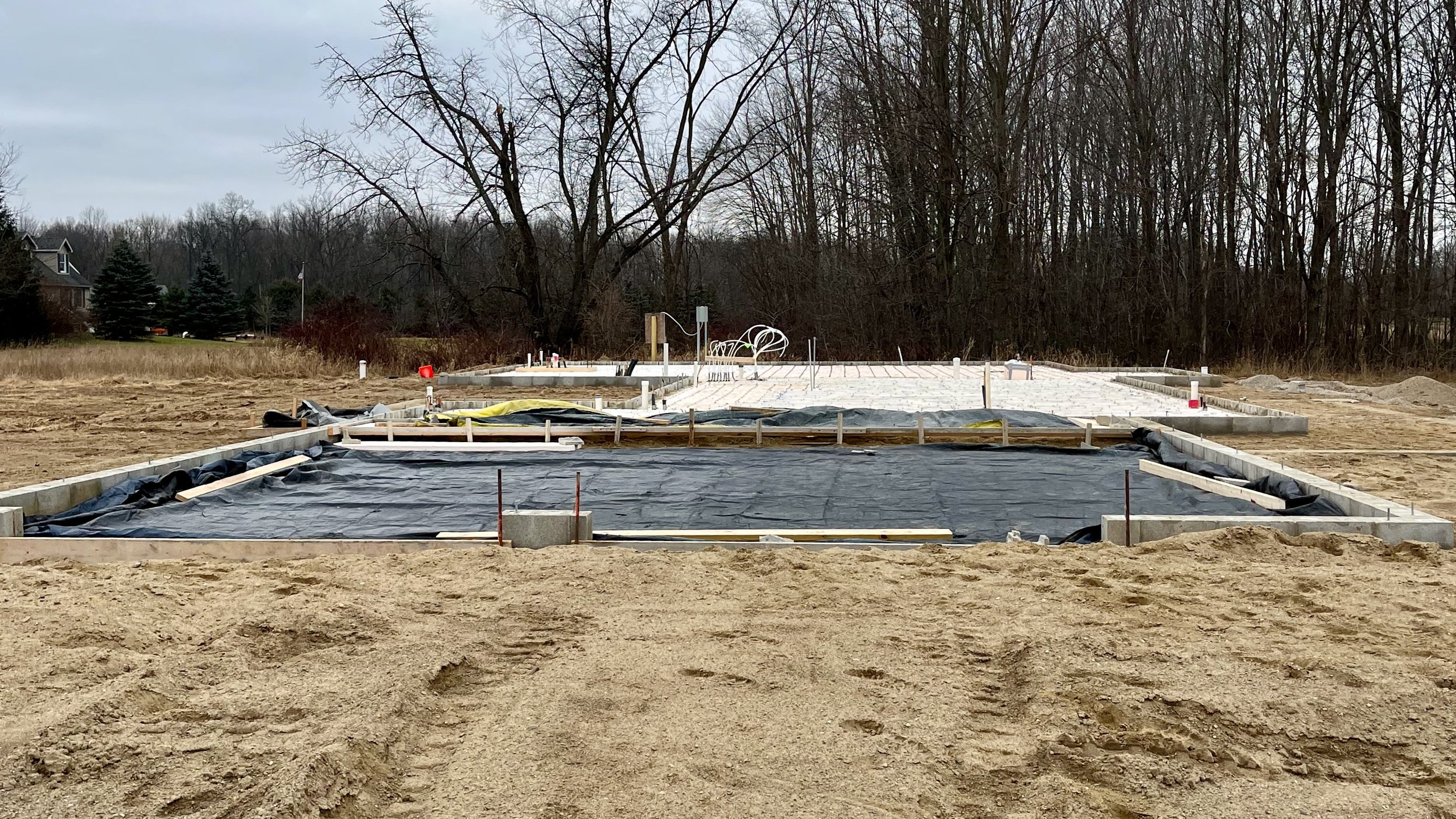 A foundation of a new home with piping installed to heat the floor slab during colder months.