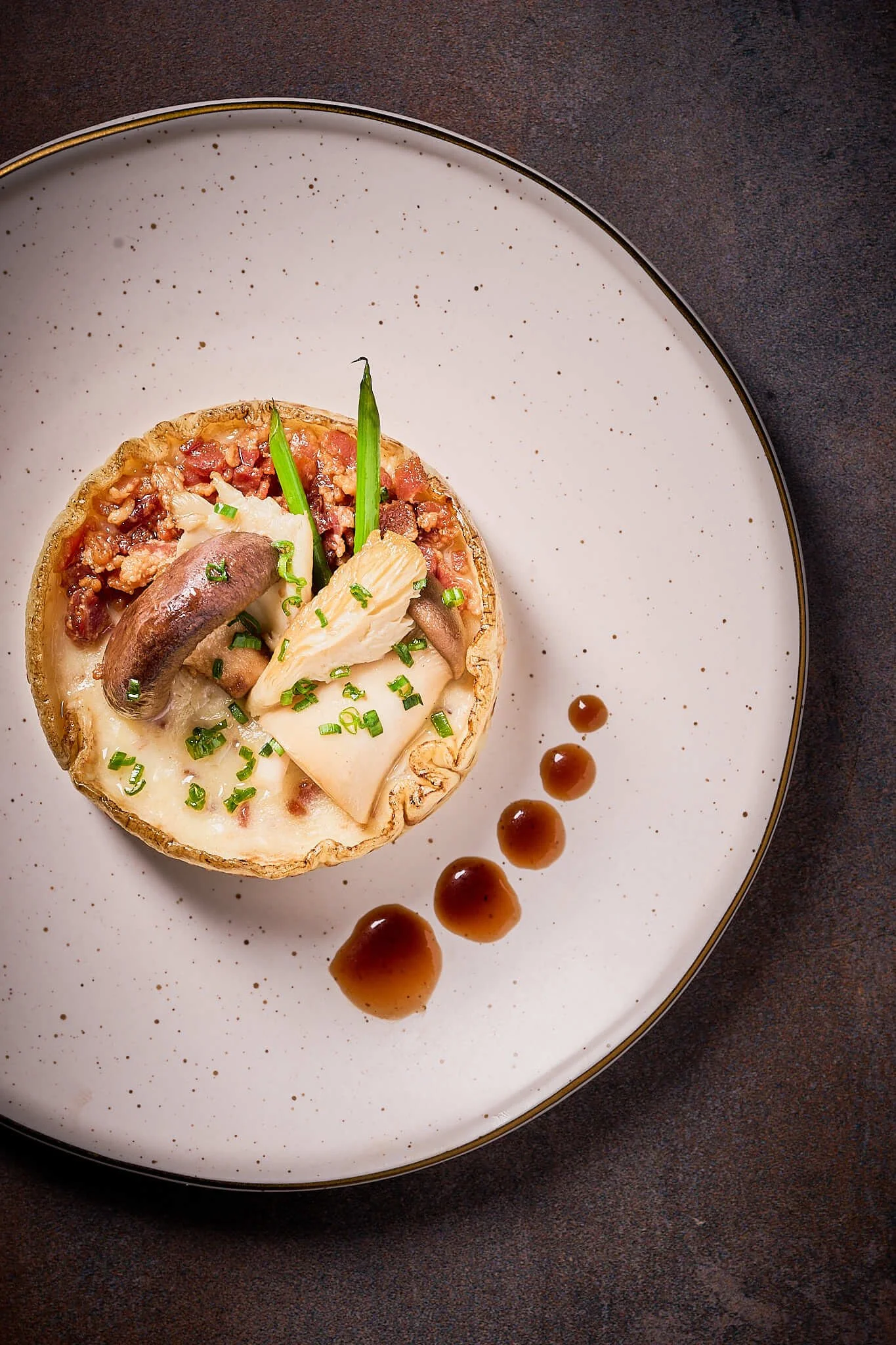 Crepe "Vonaissiens" (French Potato Crepe) with Caramelized Onion, Creme Fraiche, Smoked Bacon, Sauteed Chanterelles, Bordelaise plated on a white plate for an elevated private dinner party in chicago by Private Chef David de Quay