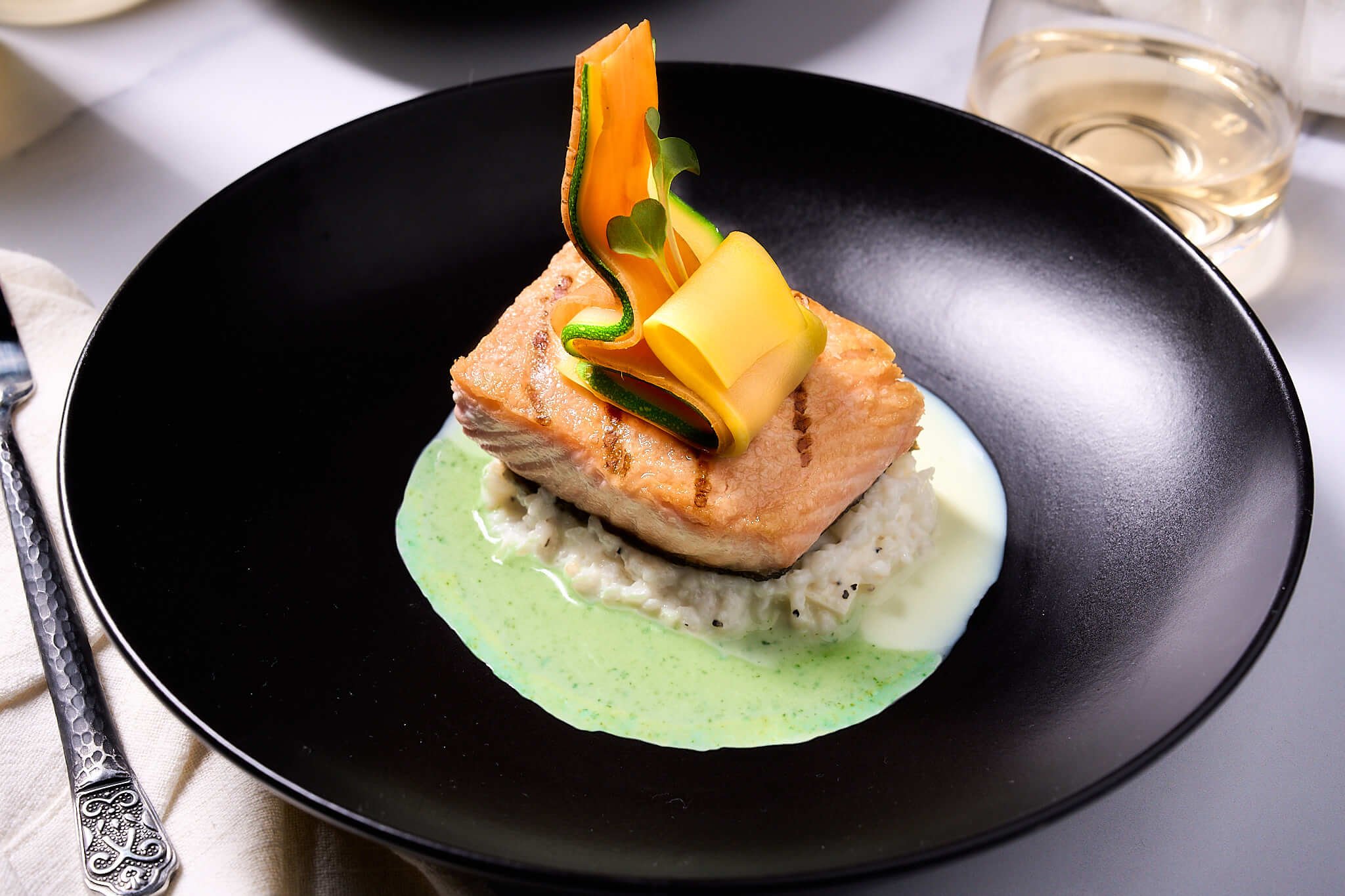 Plated Grilled Salmon, Truffle Risotto, Celery Root and Tarragon Veloutes, Zucchini, Yellow Squash, and Carrot Curls created by Private Chef in Chicago, David de Quay