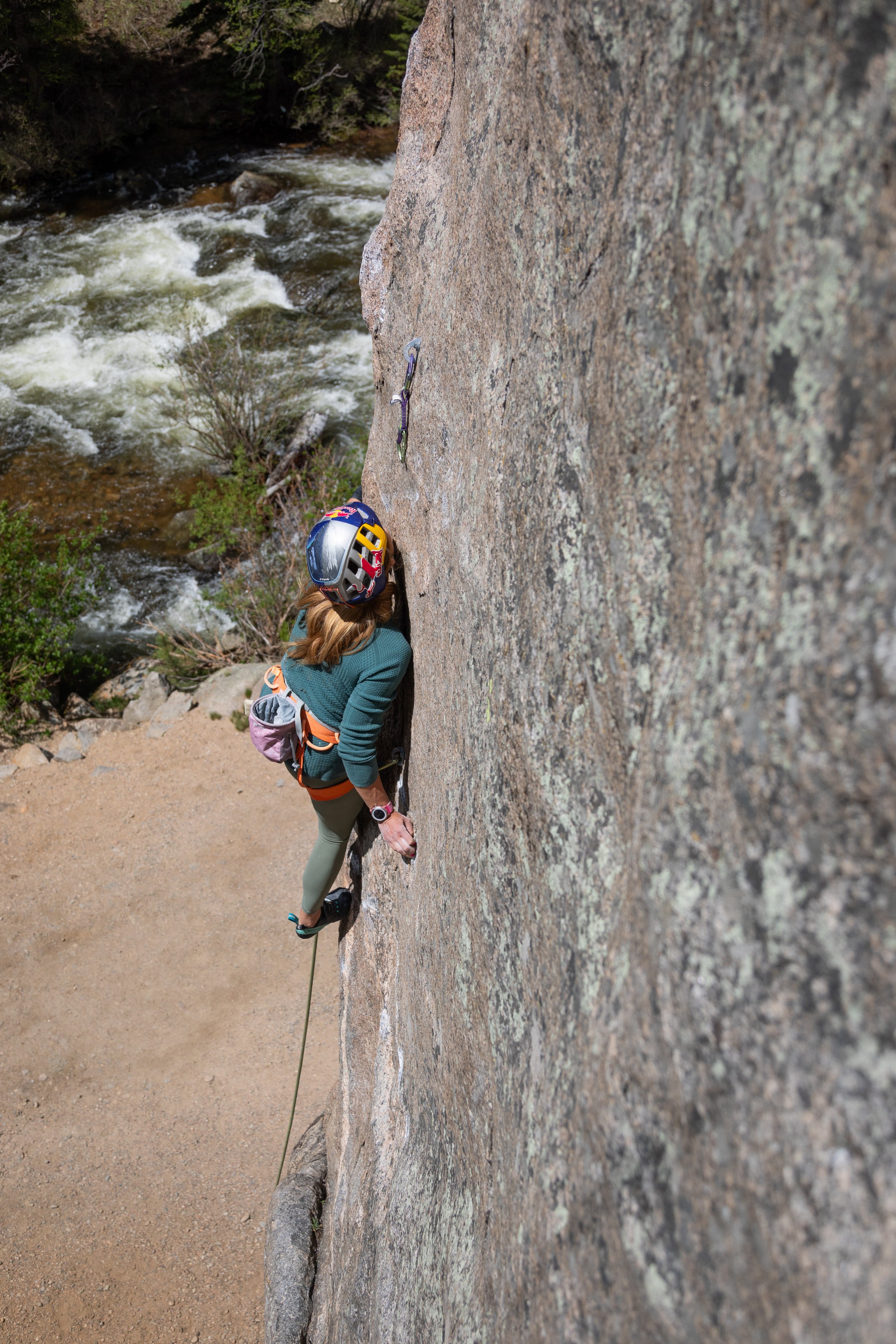 As DigIulian ascends her route, she keeps her body close to the wall to help her balance.