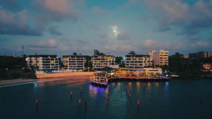 Mombasa after dark. 
From above, the city becomes a circuit board &mdash; streets pulsing gold, rooftops fading to shadow, the coastline tracing its own quiet rhythm against the Indian Ocean. Somewhere in the current, English Point Marina holds its g