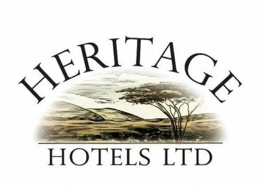 Heritage Hotels Ltd logo with a landscape of trees and hills.
