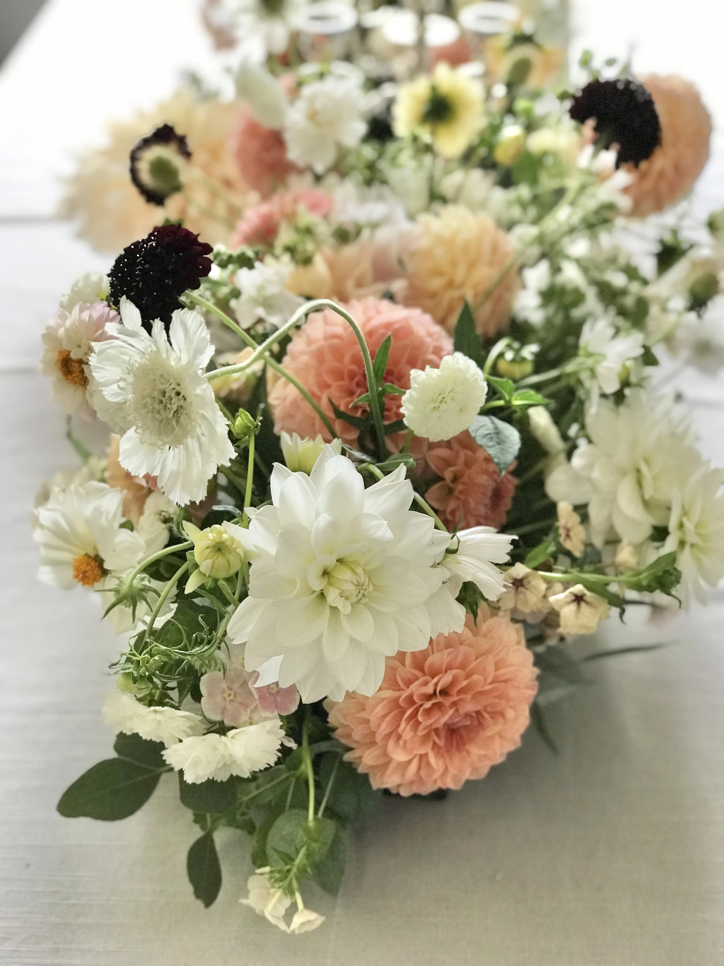 Summery peach and white dahlias table arrangement 