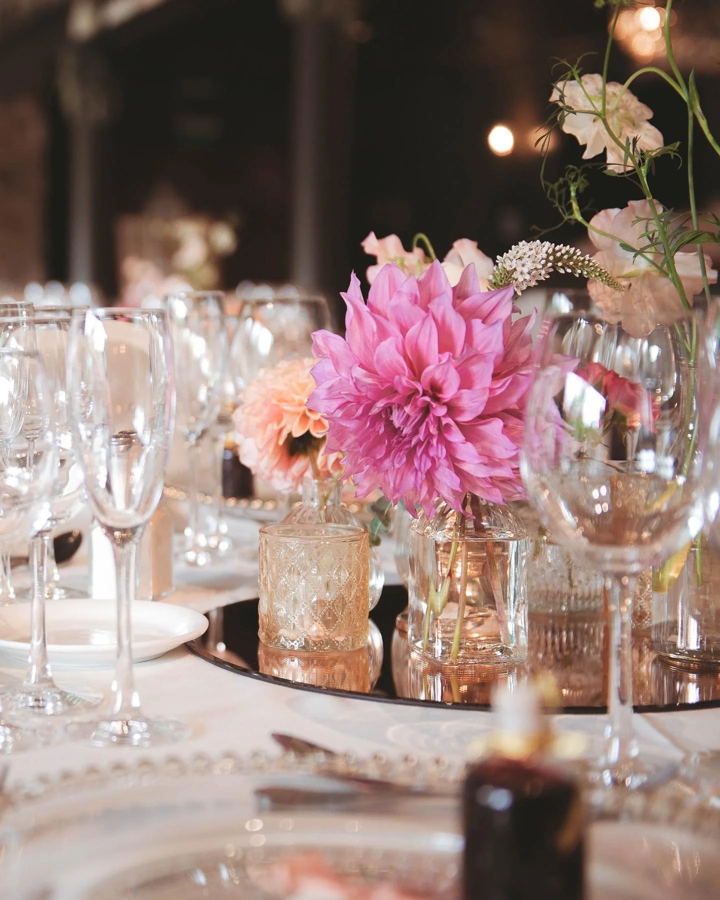 Bud vase table centre with pink dahlia