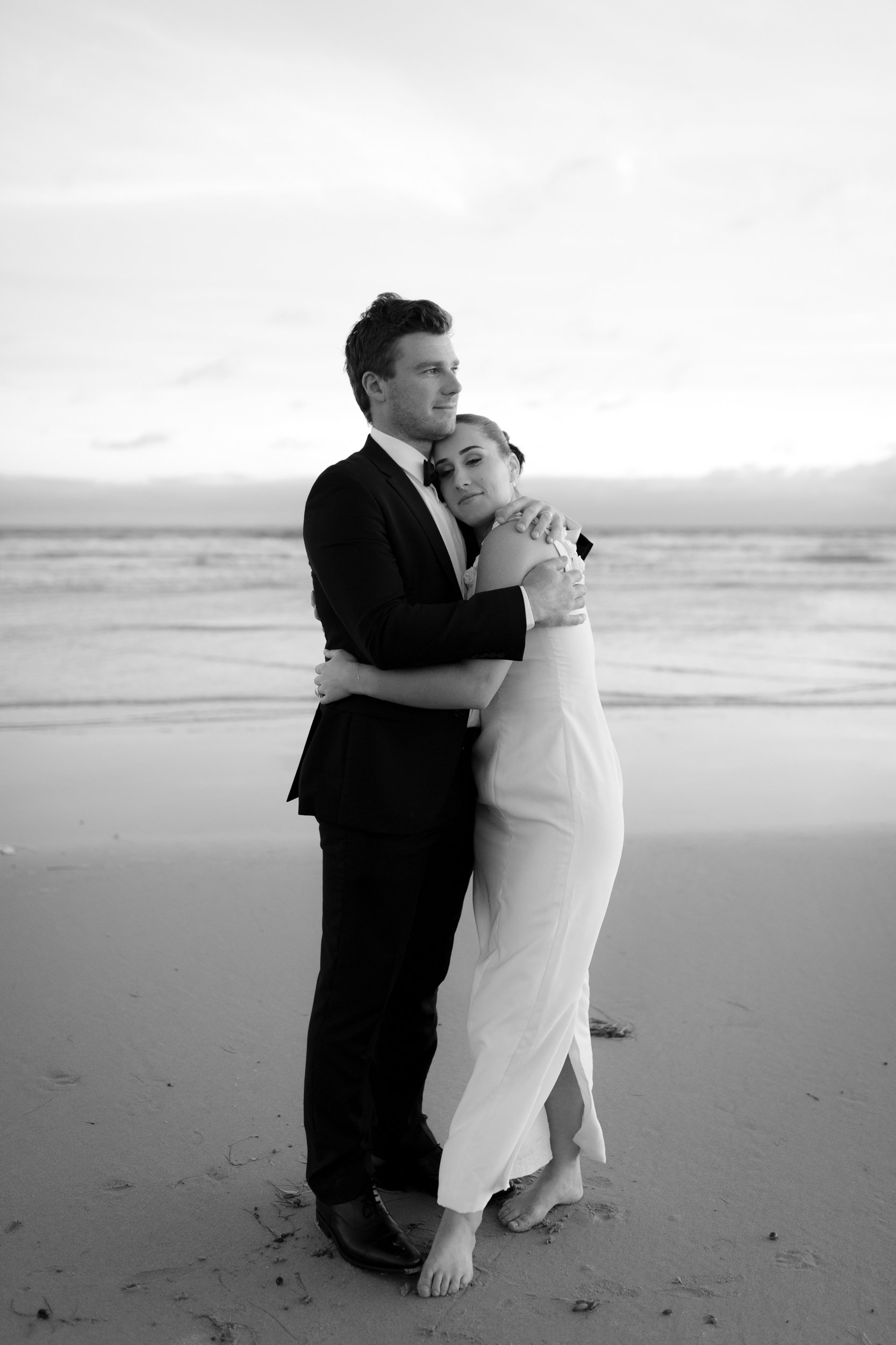 Annie and Liam embracing at The Dunes in Ocean Grove after their coastal wedding, captured by Geelong photographer Tal Lemmens.