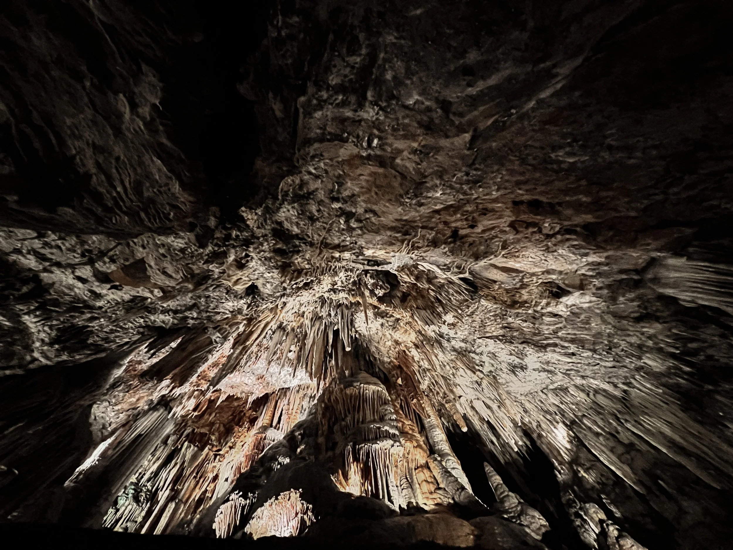 Soft limestone formations inside Valporquero Cave, suggesting a natural spatial sequence through stone, shadow and mineral matter.