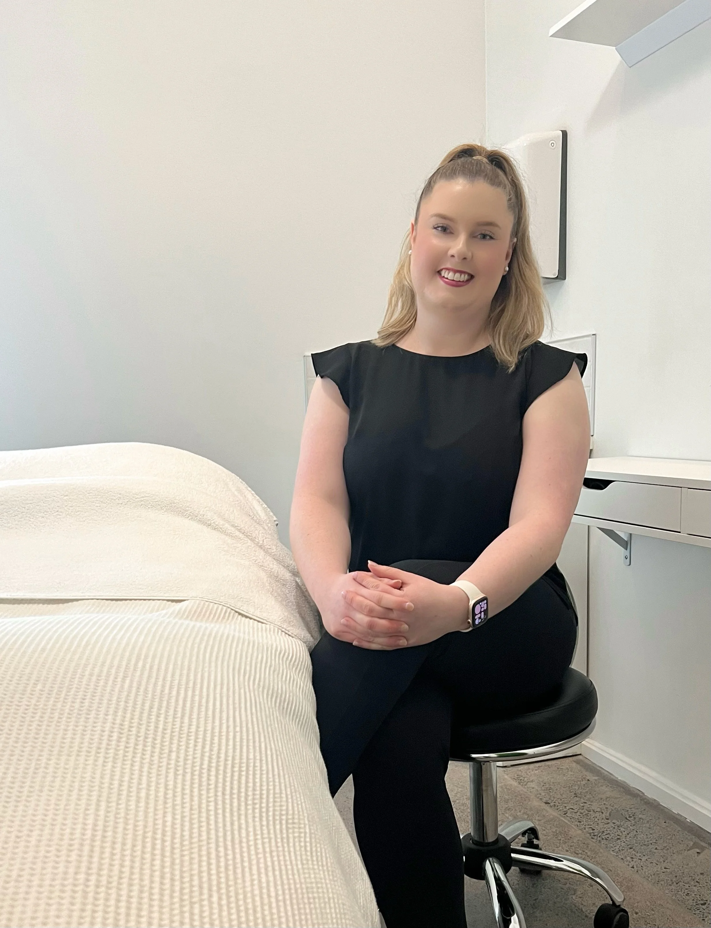 Michelle, medical skin therapist and founder of MiSkin, seated in a private skin treatment room at the Auckland clinic.