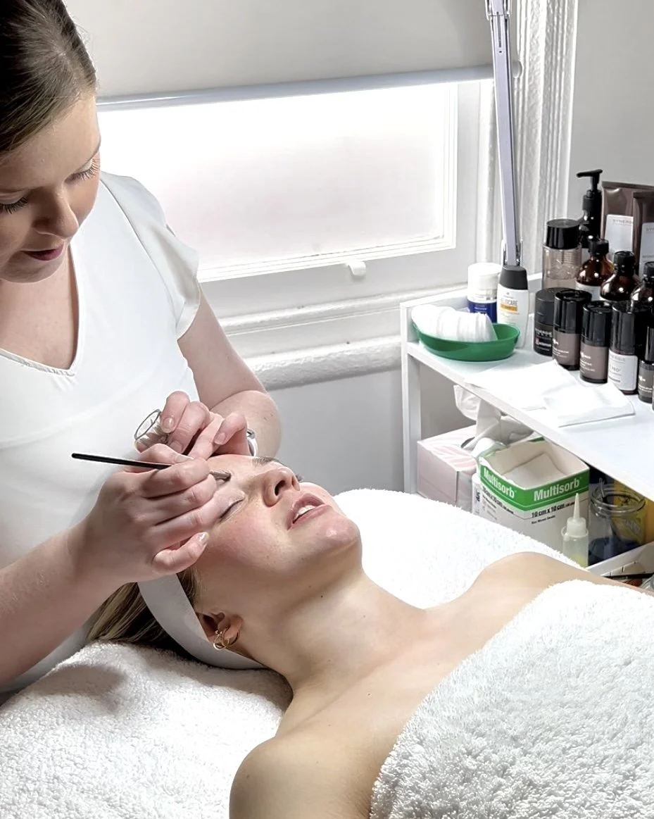 A woman receiving a facial treatment from Michelle at MiSkin.