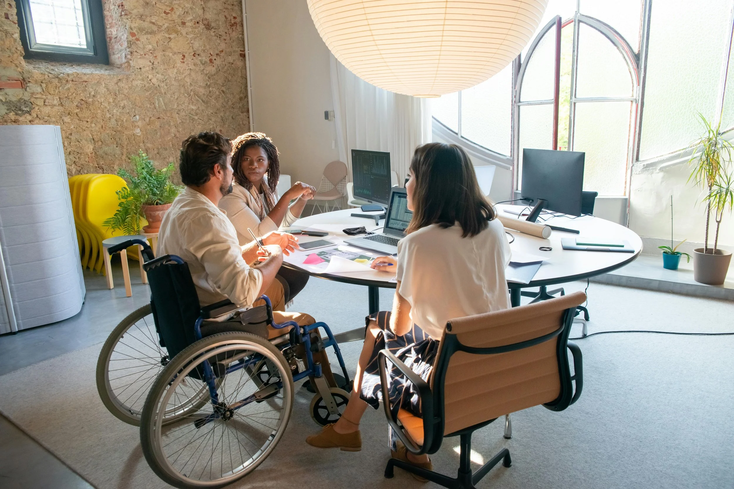 Diverse group of colleagues collaborating around a table during a strategy meeting