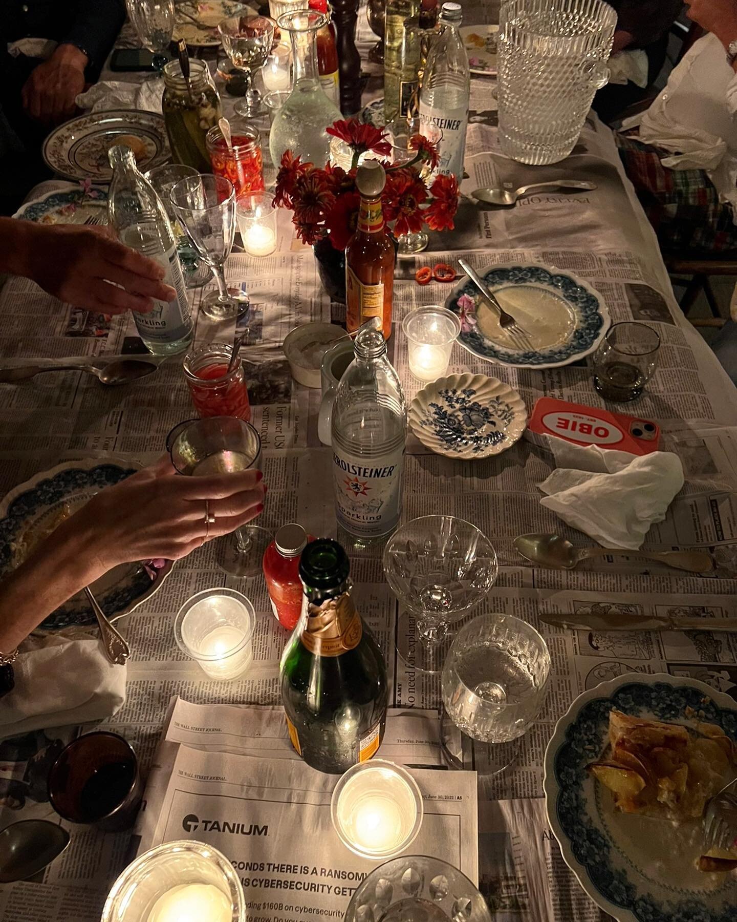 this is how we gather #friedchicken #grits #champagne #collards #homemadepickles #friedgreentomatoes #pickledonions #appletart newspaper as tablecloth #kateandamystyle #entertaining #wherewegather