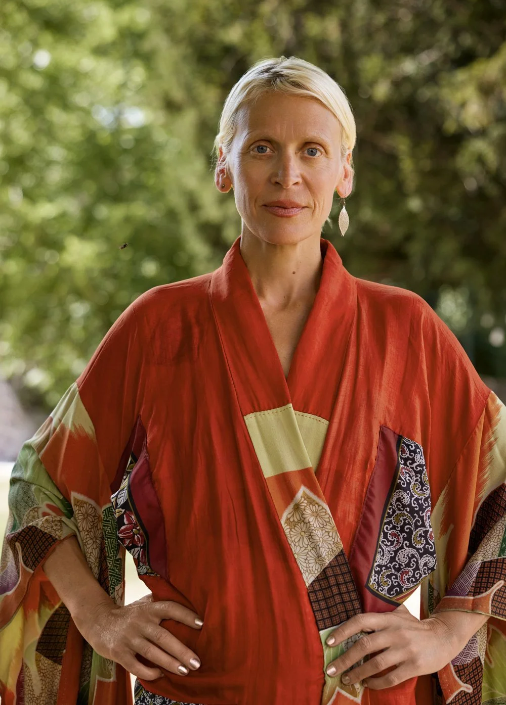 woman wearing one of her vintage maple leaf motifs kimonos in the garden of her house