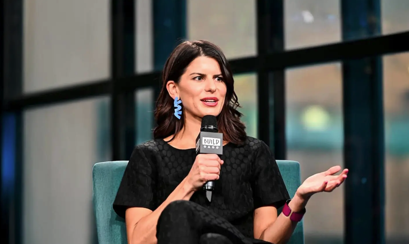 Margaux speaking on stage at Build Studios in New York City