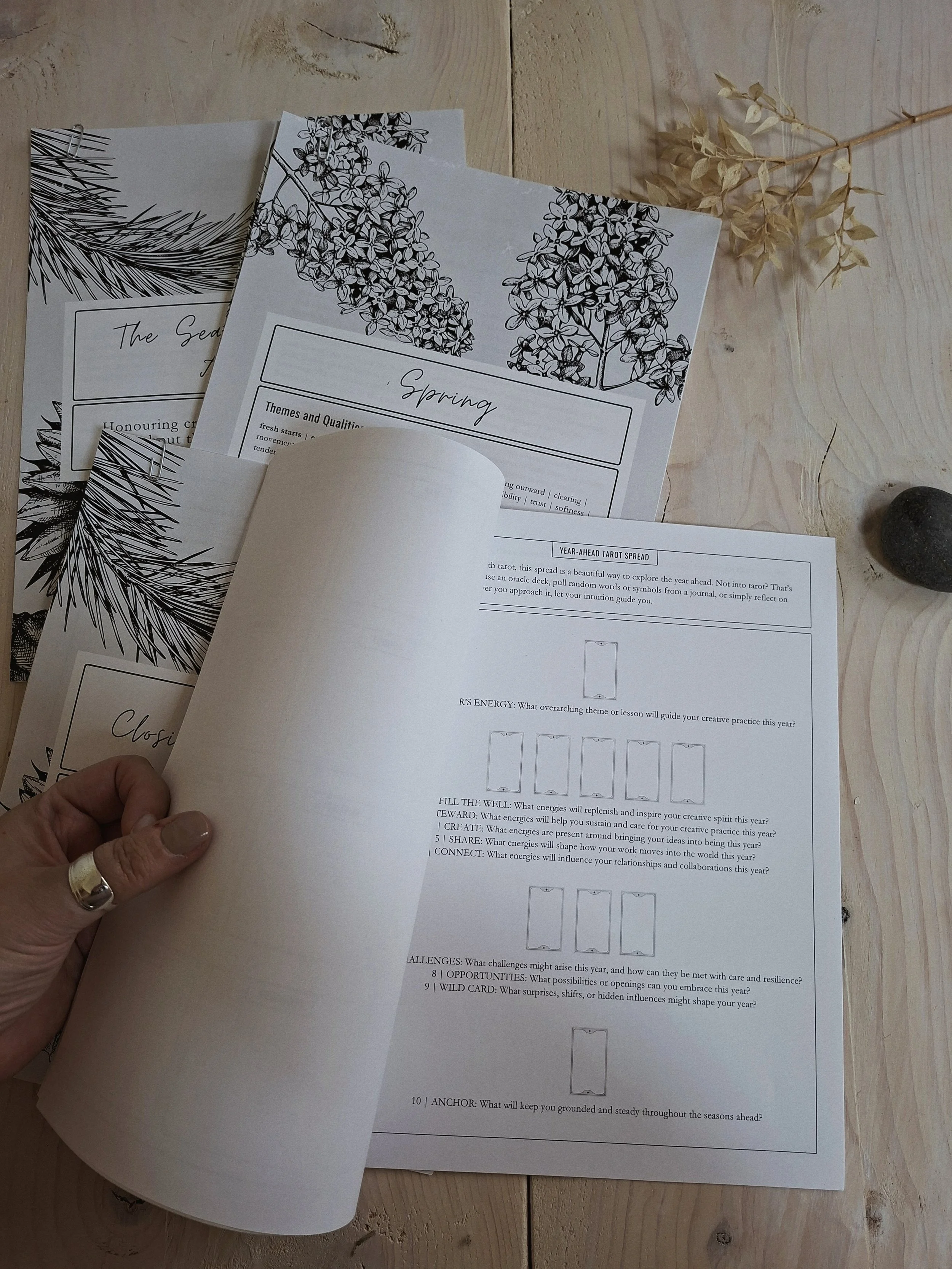 The Seasonal Creator Almanac open to a workbook page with a tarot spread.
