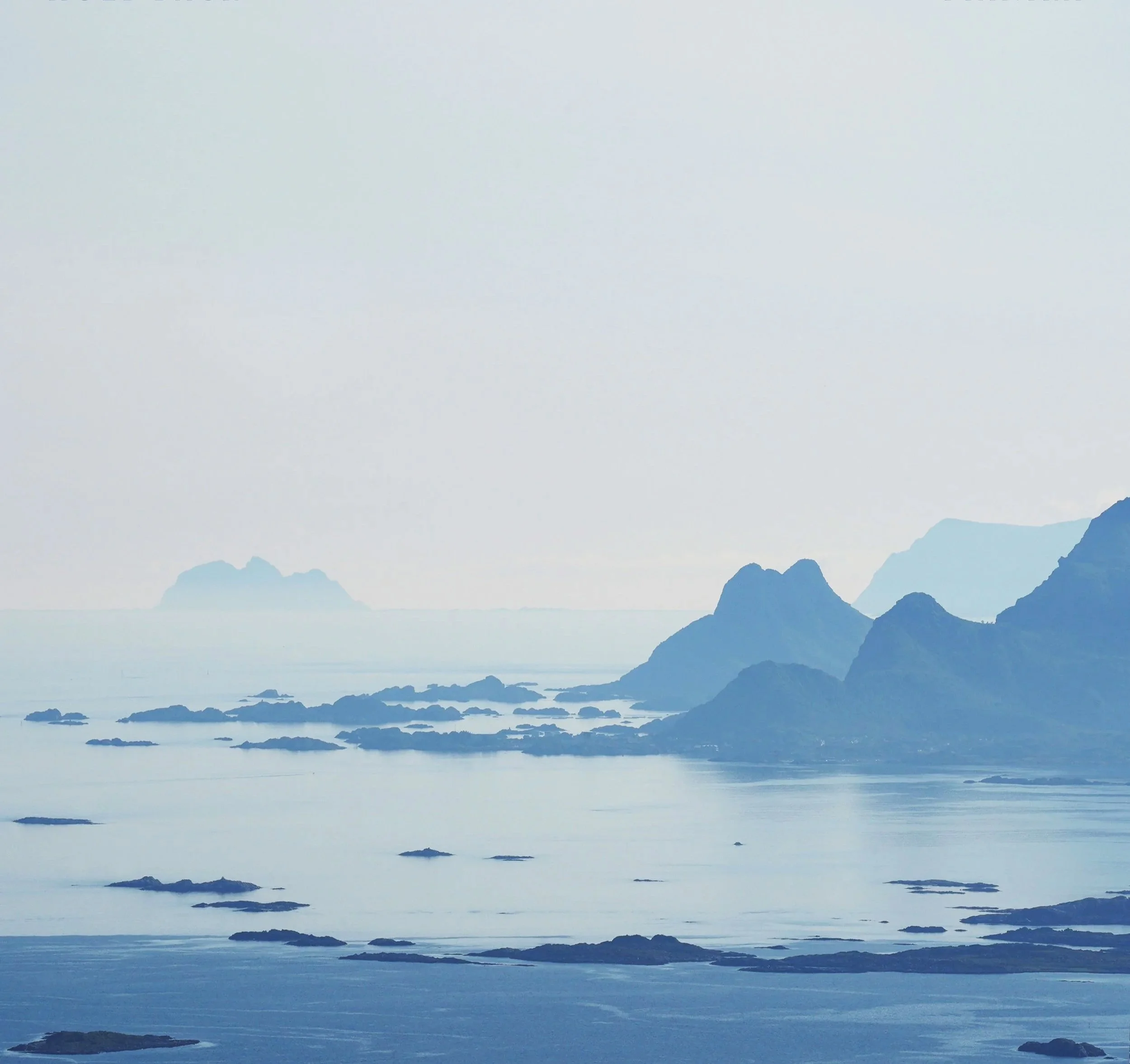 Scattered islands and dramatic landscapes emerging from a glassy calm sea