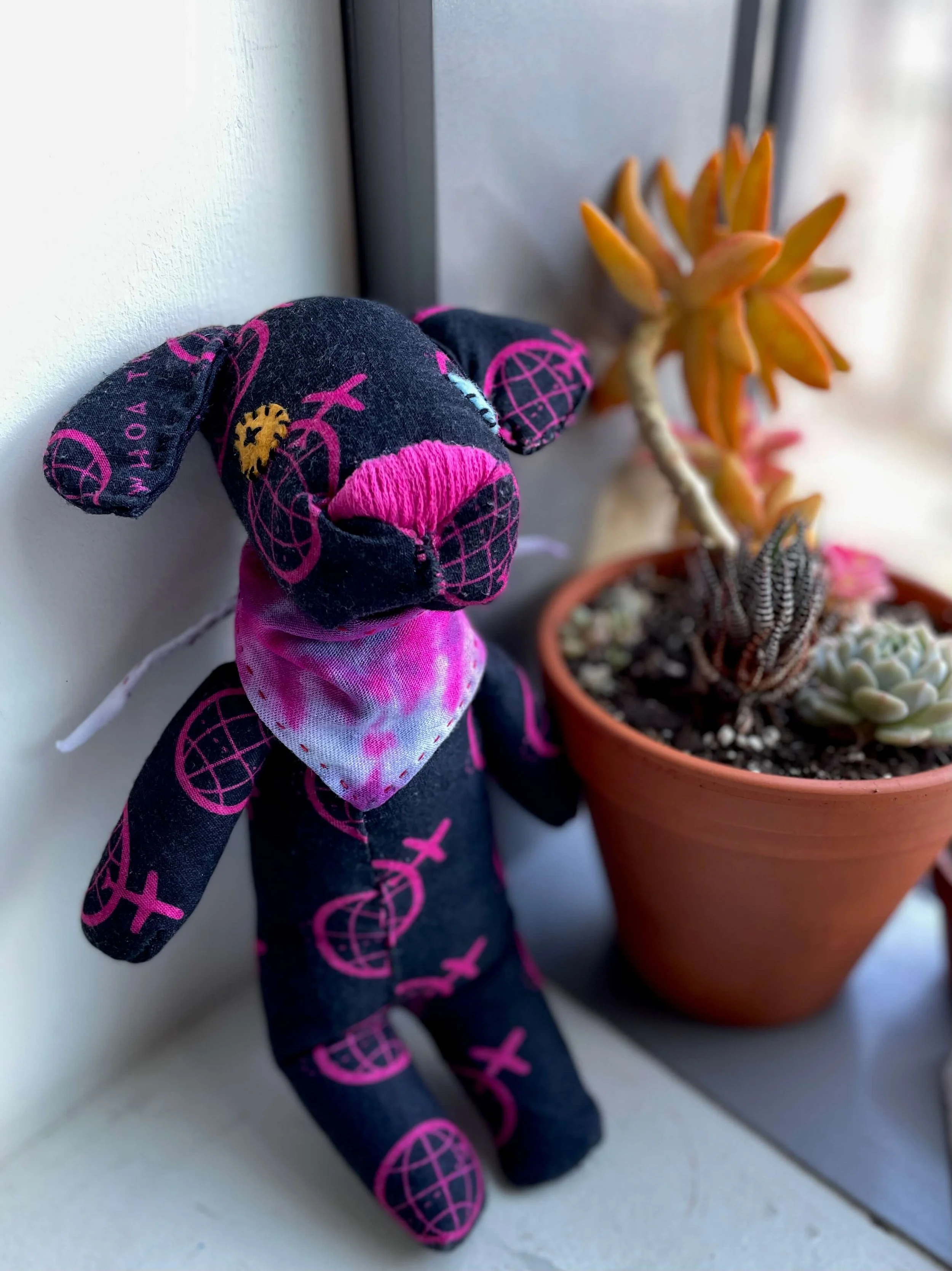 Dog stuffie, a baby gift for a friend who owns an adventure travel company, hand-sewn using their branded buff.