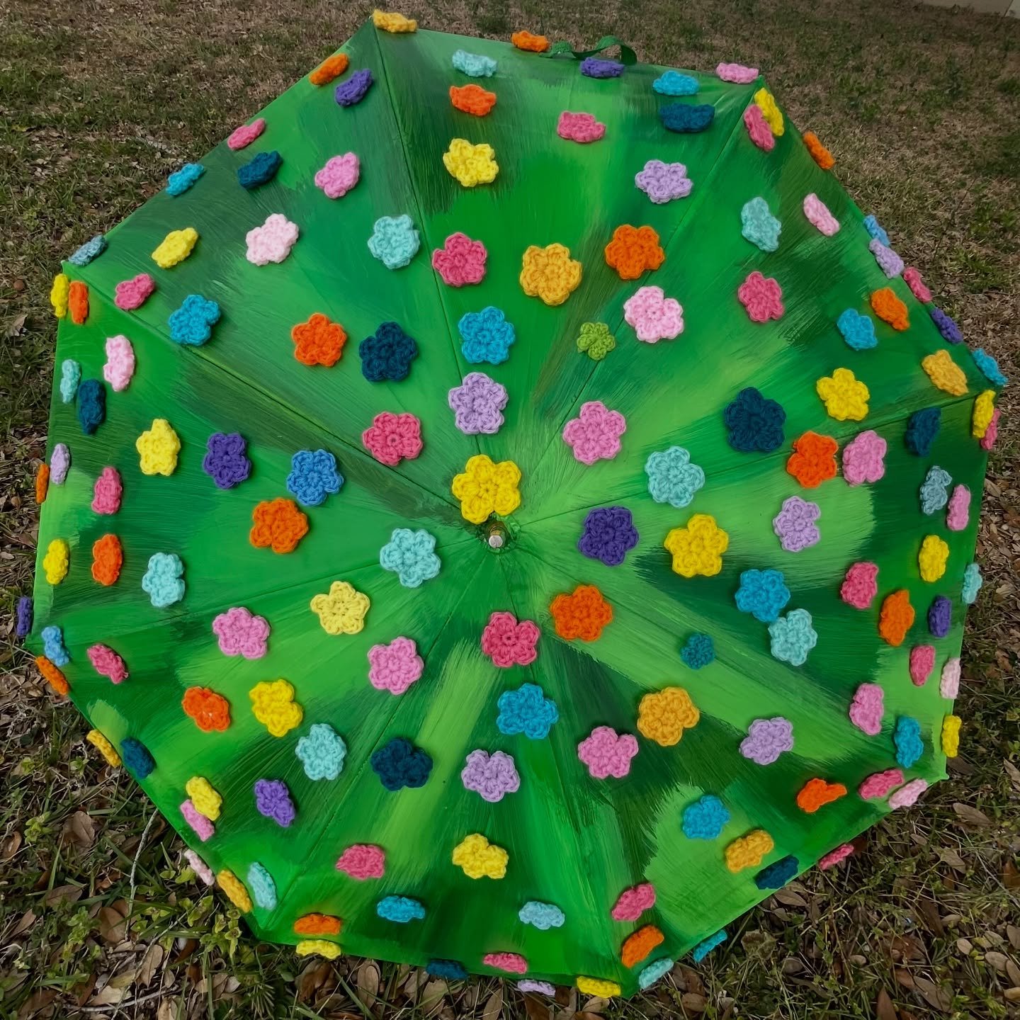 Who knew an umbrella could become a canvas? ☂️🧑🏼&zwj;🎨

One umbrella is a bold abstract flower filled with my signature squiggles, and the other is a crocheted flower field bursting with tiny handmade blooms. I loved creating on a surface I&rsquo;