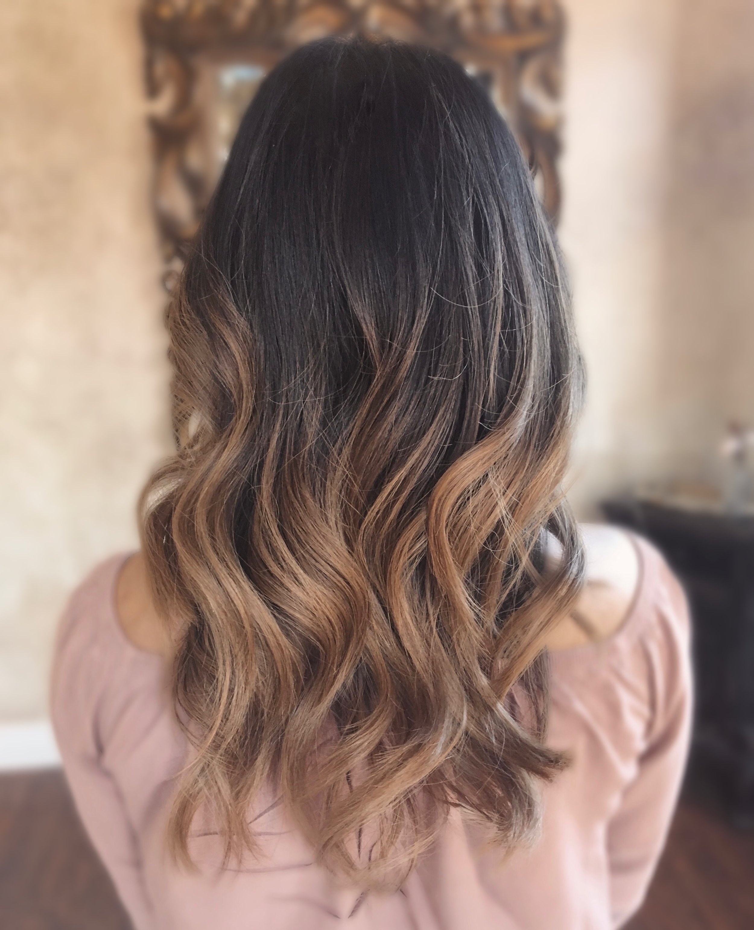 Long wavy brown hair with blonde highlights