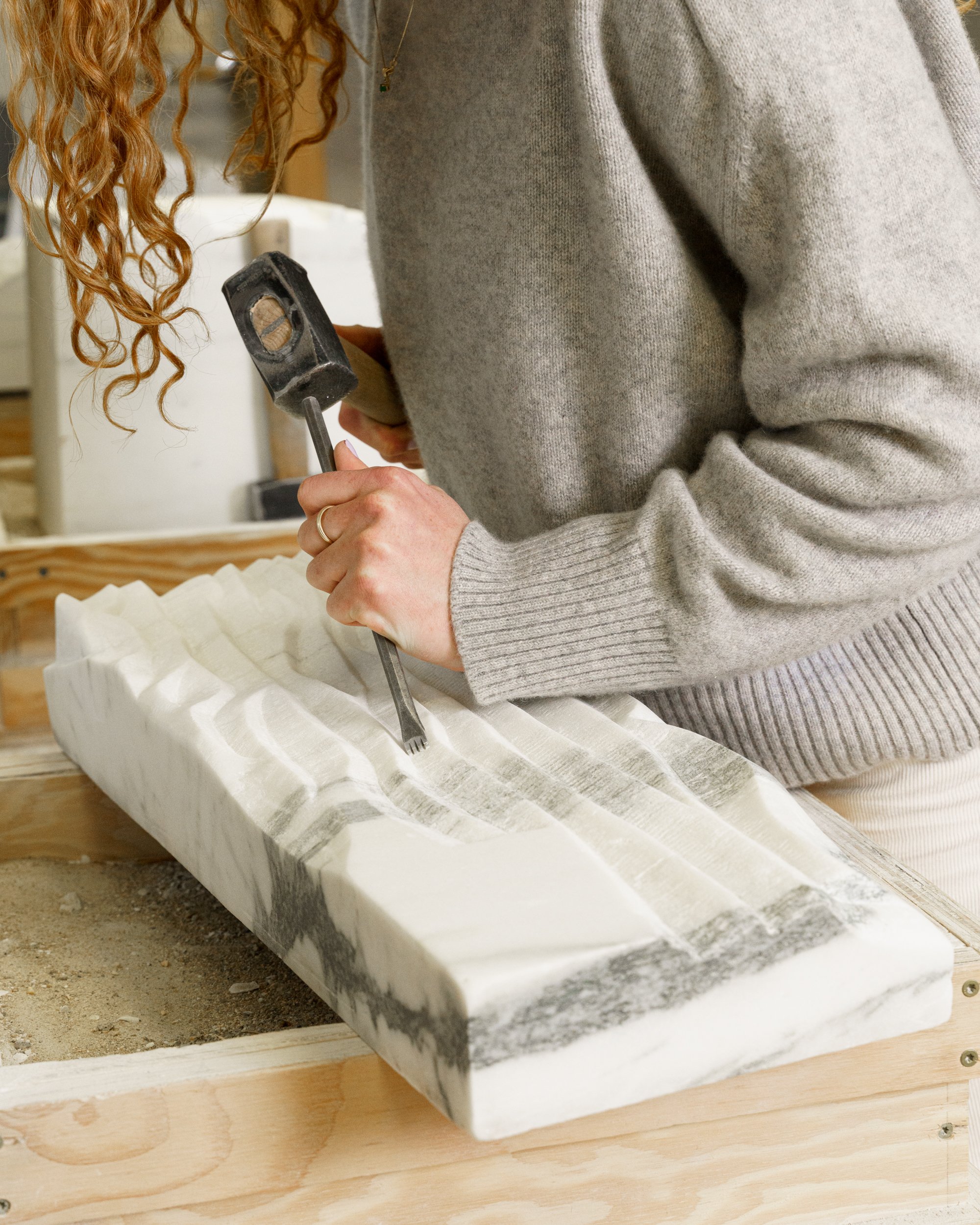 Mira DiSilvestro chiseling marble