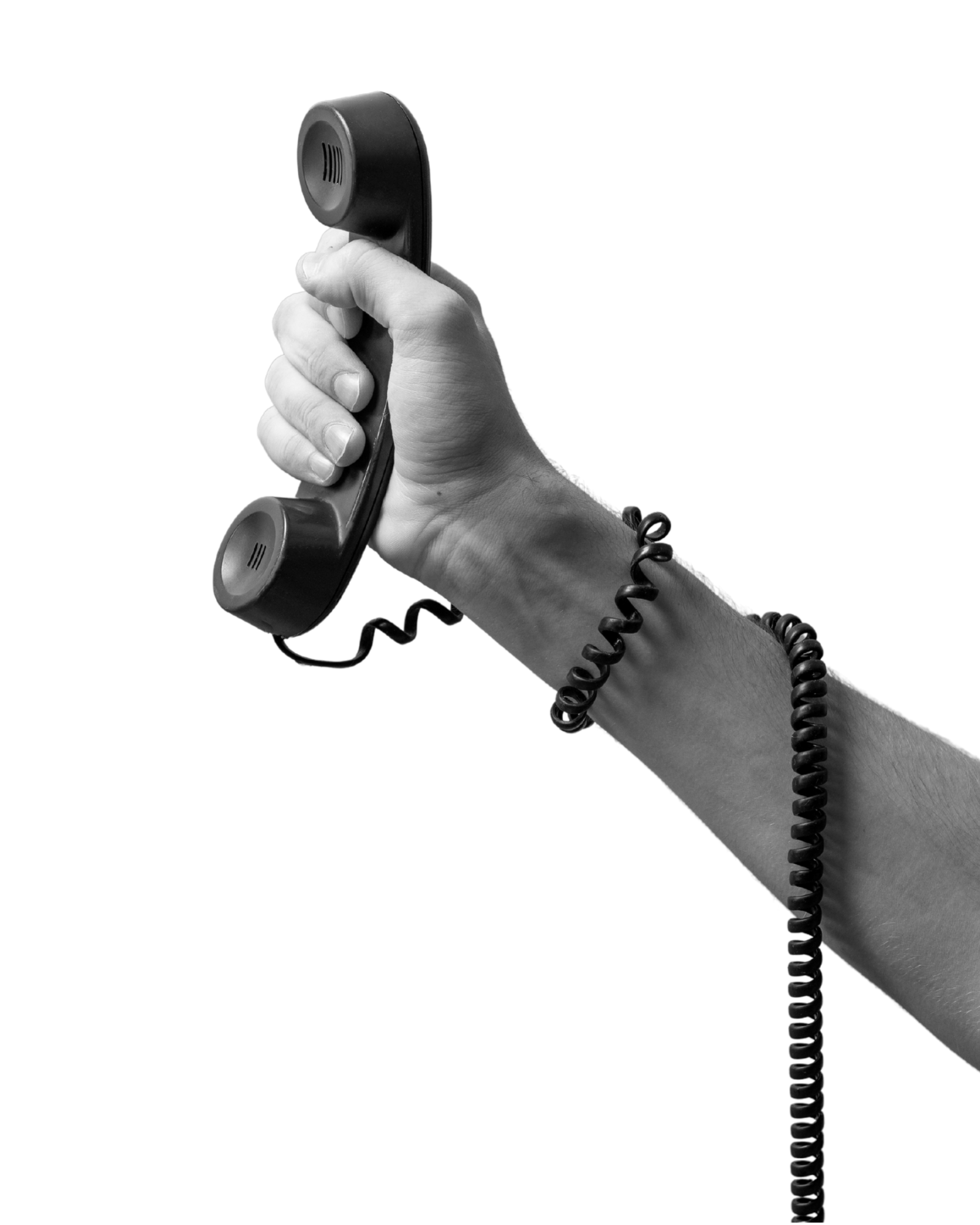 A black and white photograph of a person's hand holding a vintage telephone receiver with a coiled cord.