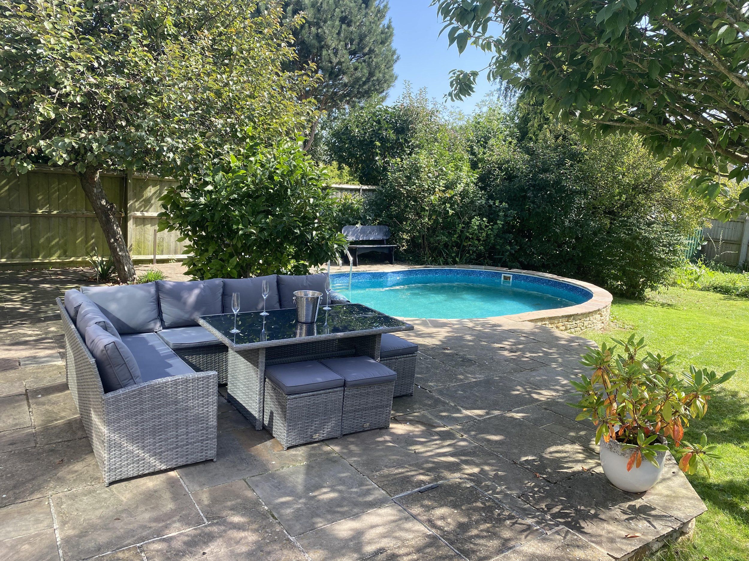 Private swimming pool and garden leading off patio area that adjoins open plan dining area from main house. An oasis of calm for your Cotswold staycation with pool.