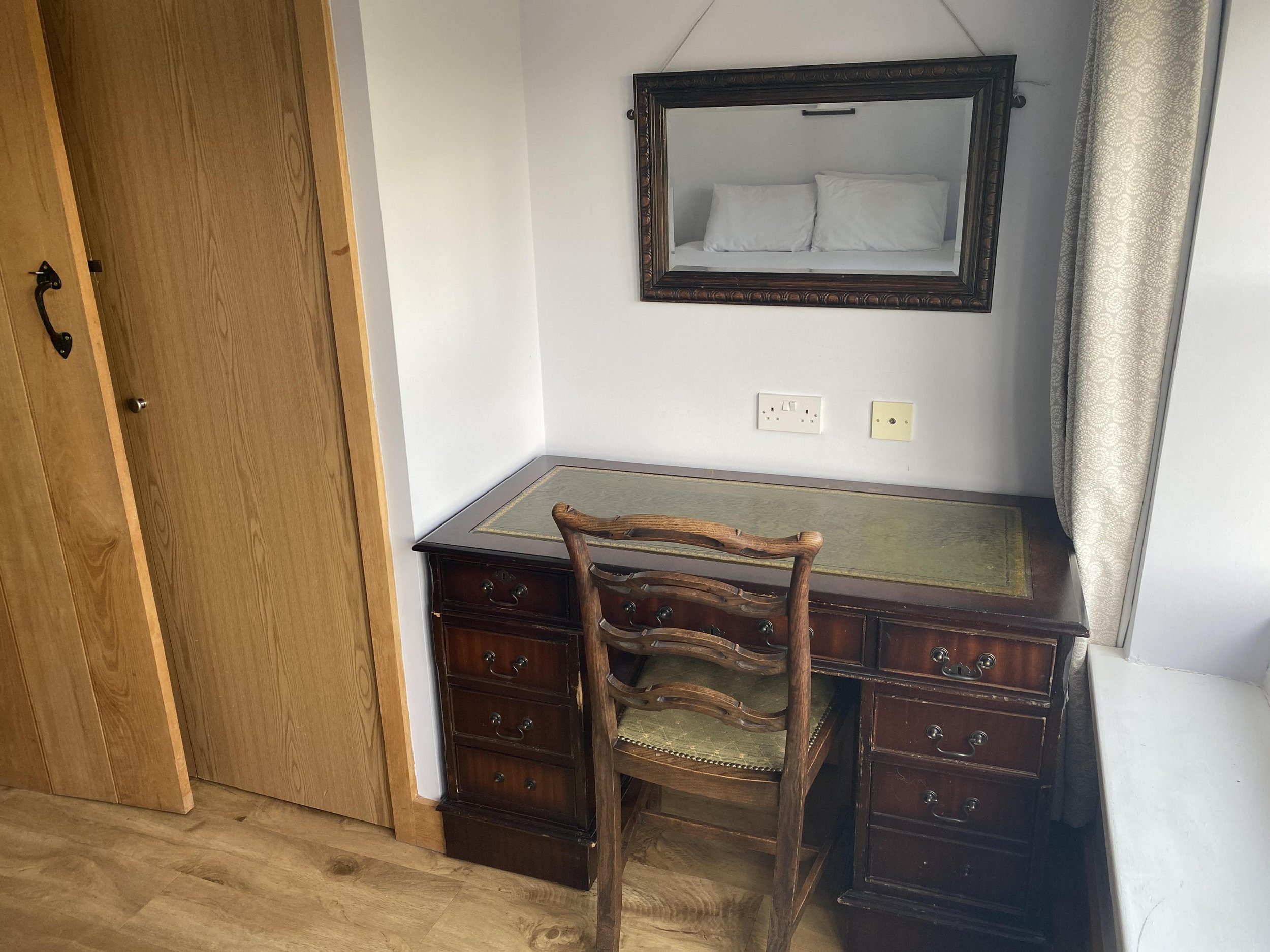 Work from home while on holiday in the Cotswolds at this antique desk with views of the garden