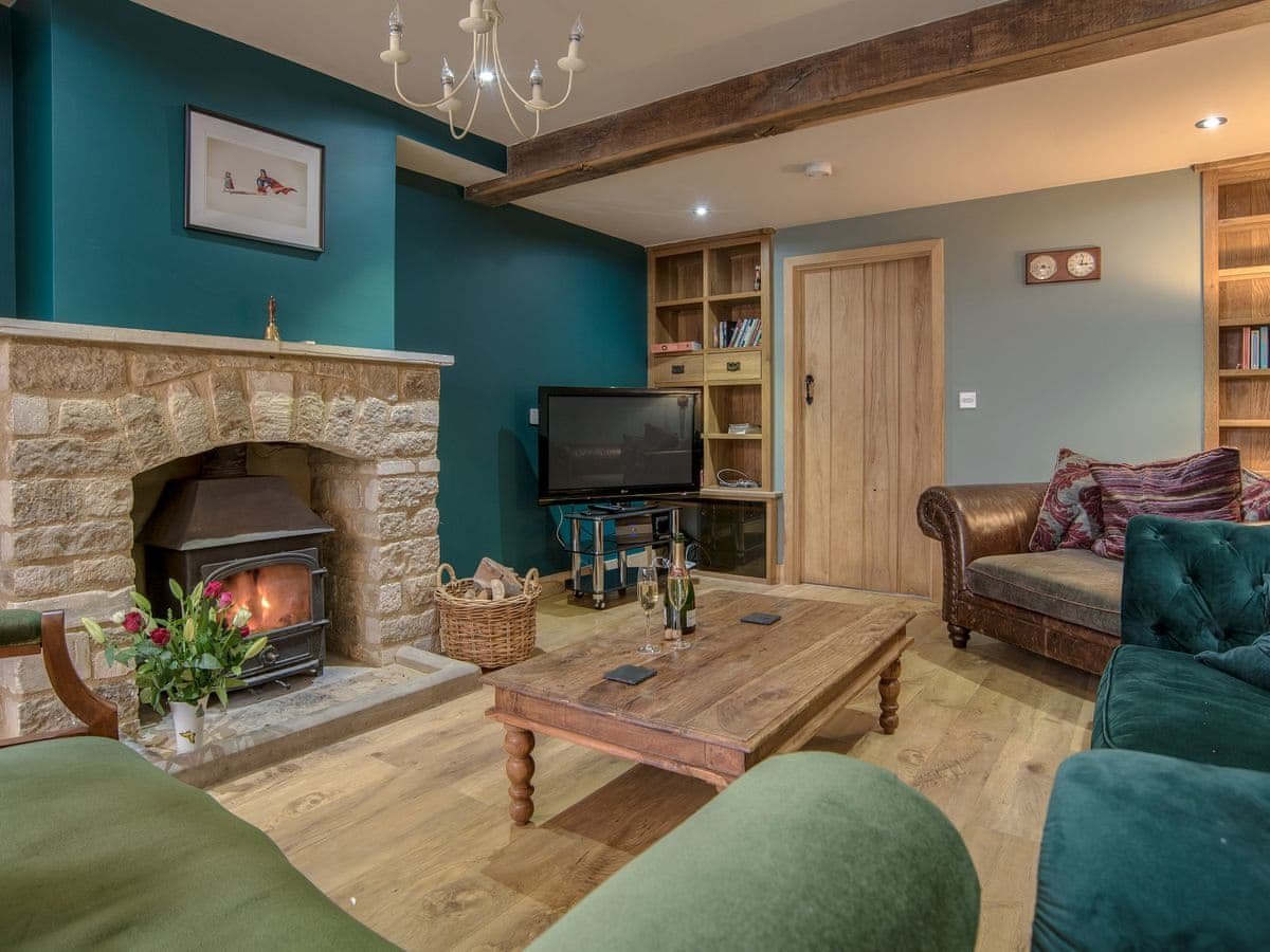 Living room / snug with log burner in Cotswold holiday let.