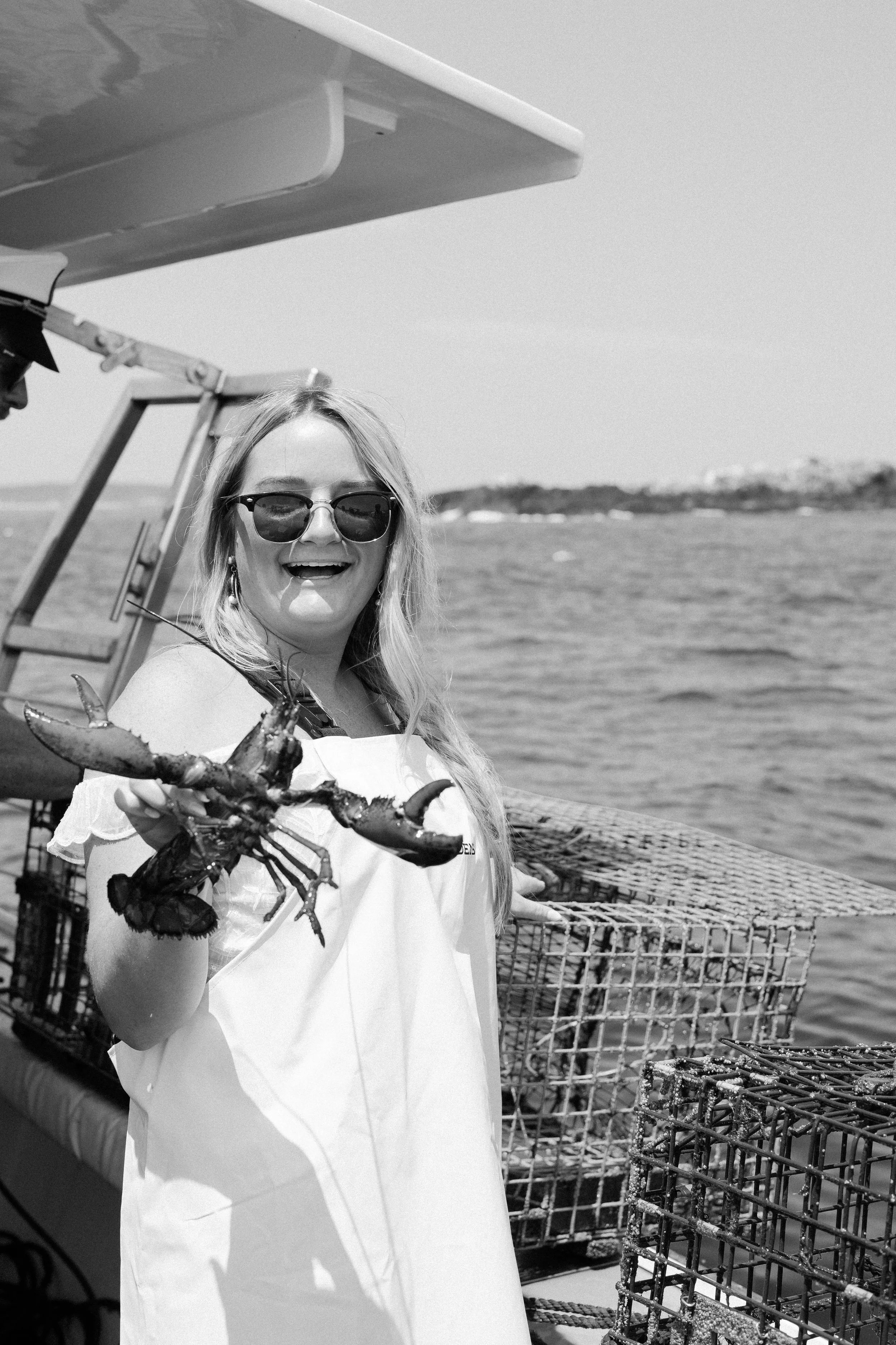 Payton holding lobster in her wedding dress