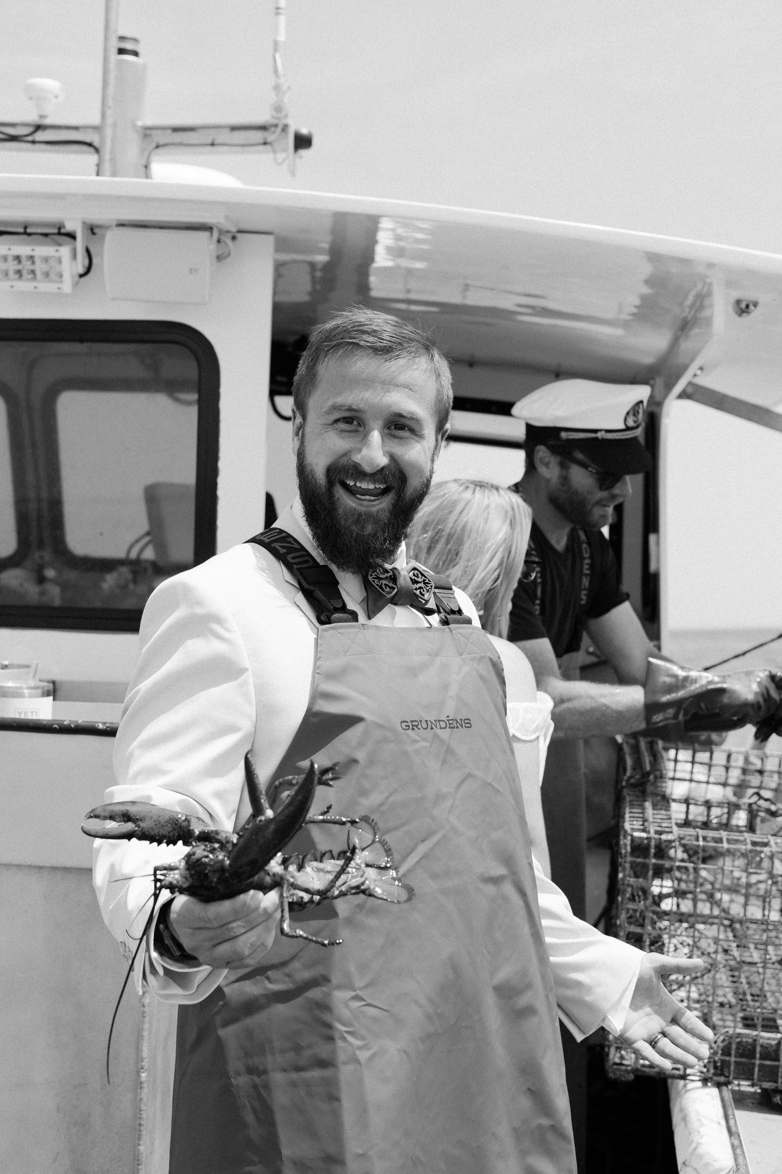 Maxwell holding lobster in his Grundens apron