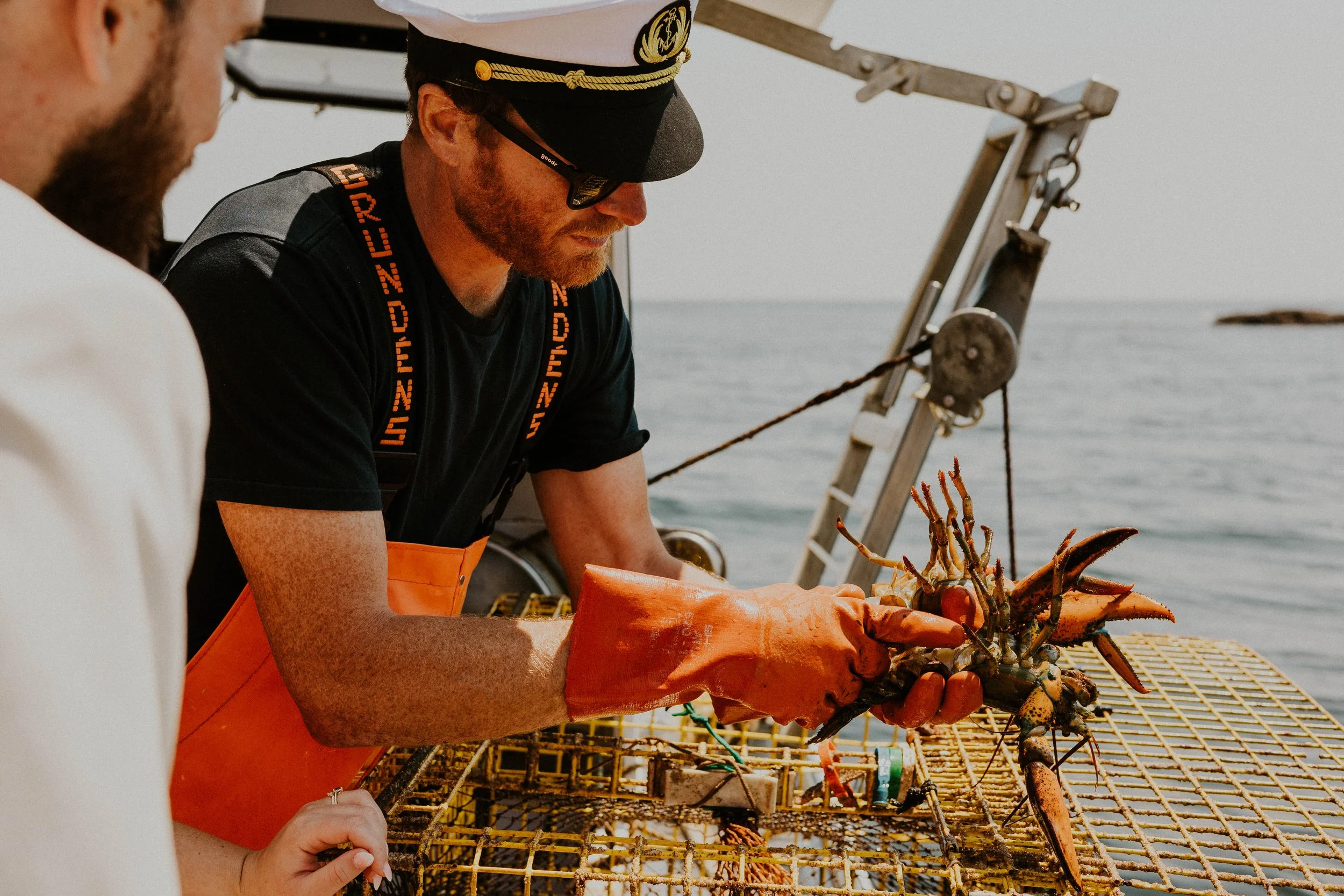 Captain Ethan measuring lobster sizes