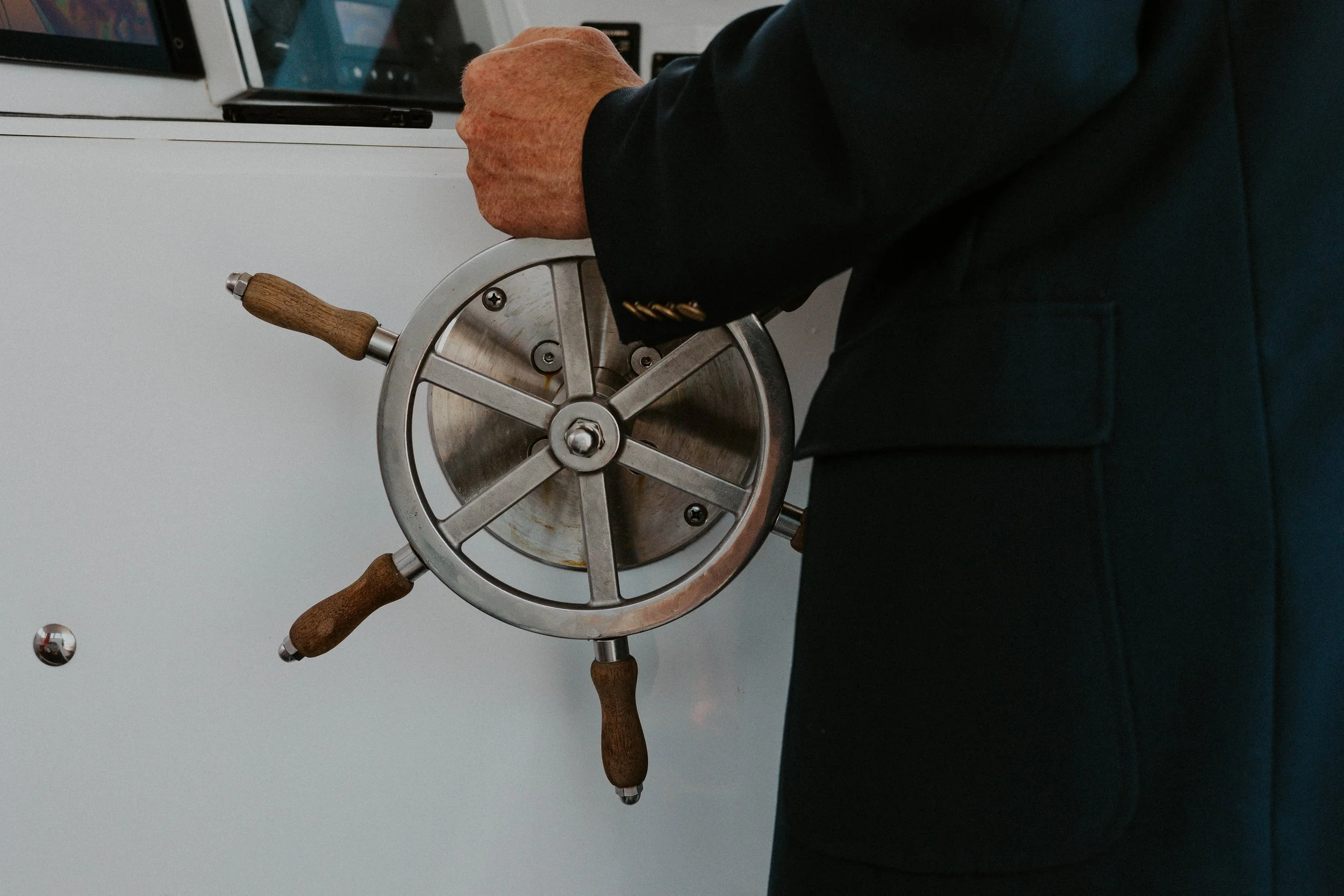 Detail of Captain Ethan's hand at the helm