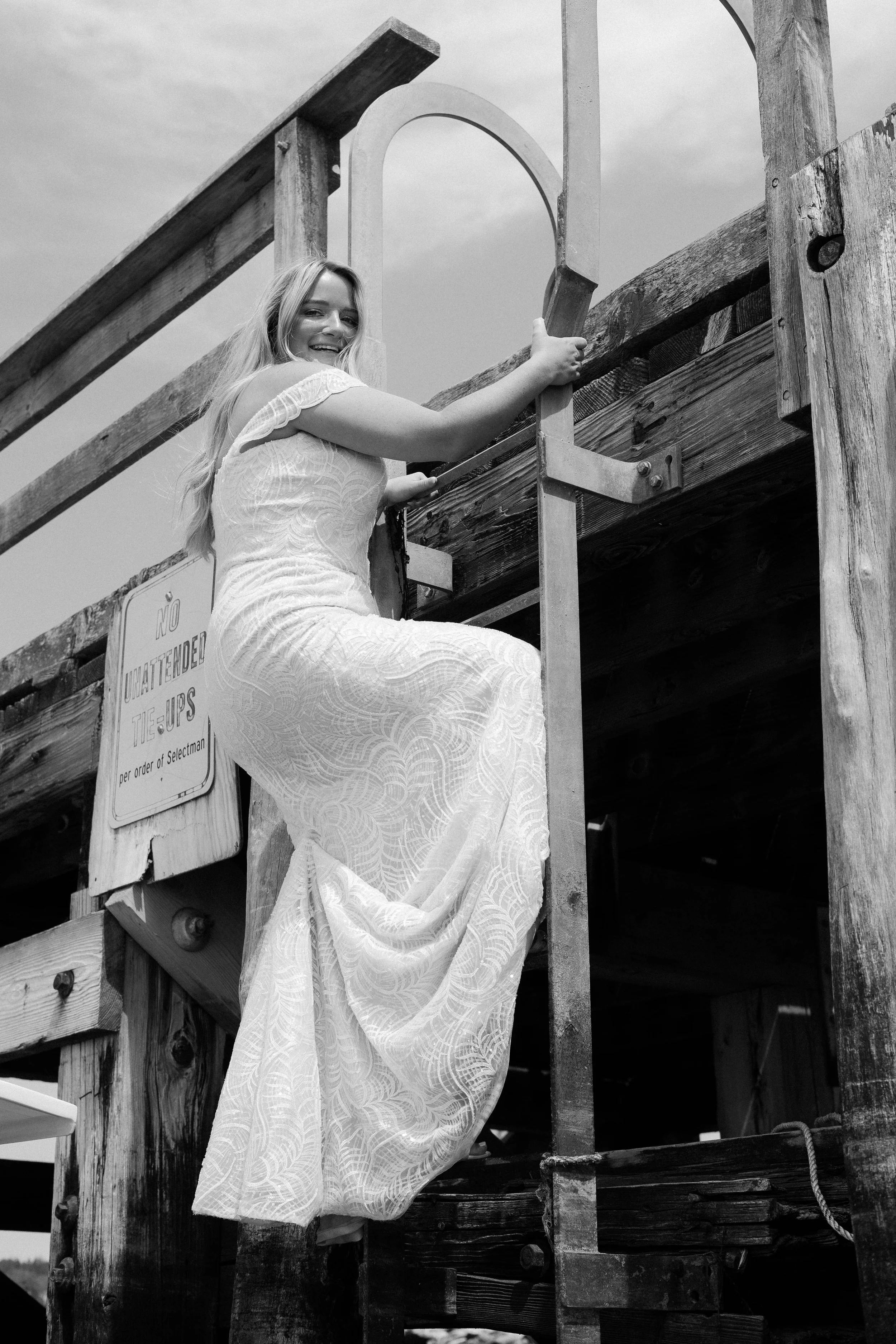 Payton climbing down ladder in bridal gown