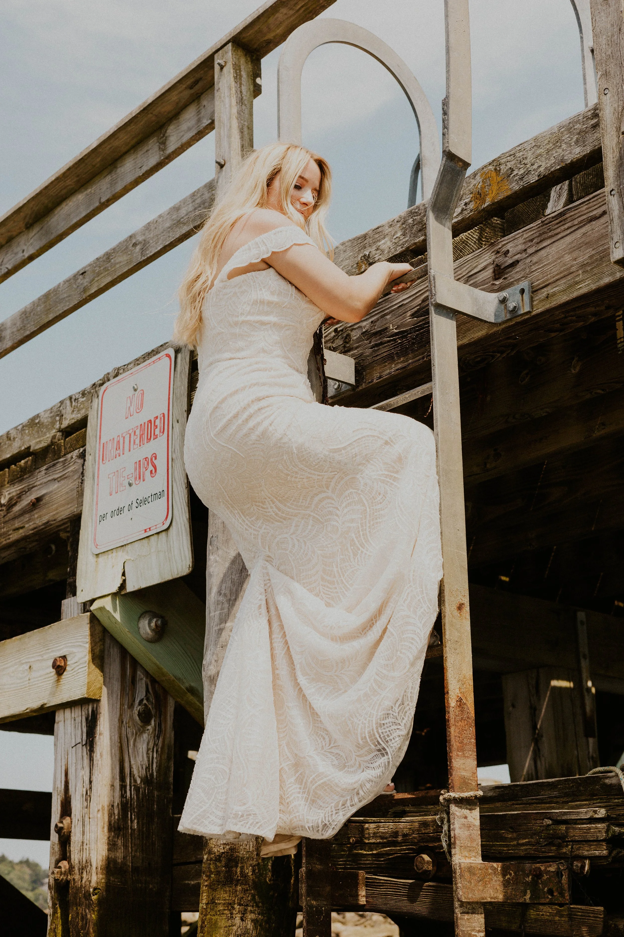 Payton climbing down ladder in bridal gown