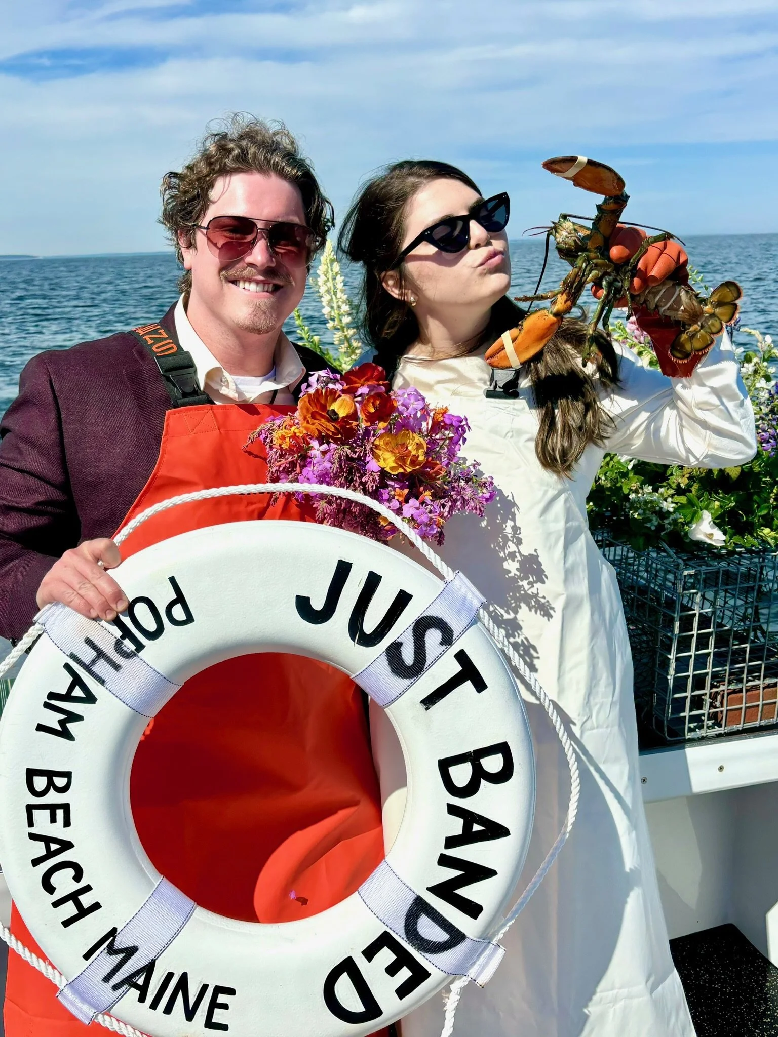 newly married couple celebrating on boat in coastal Maine