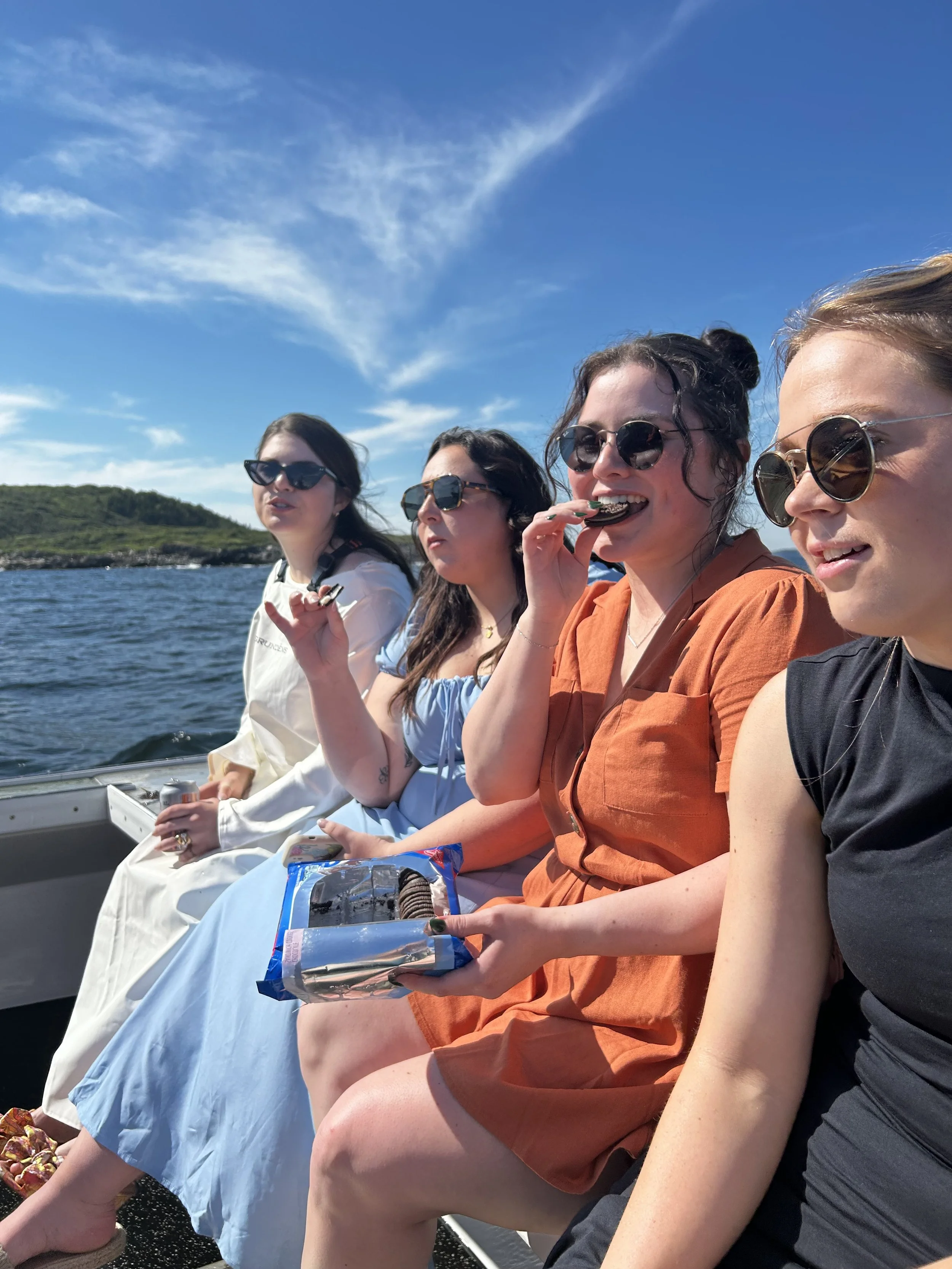 guests gathered on boat for intimate Maine elopement ceremony